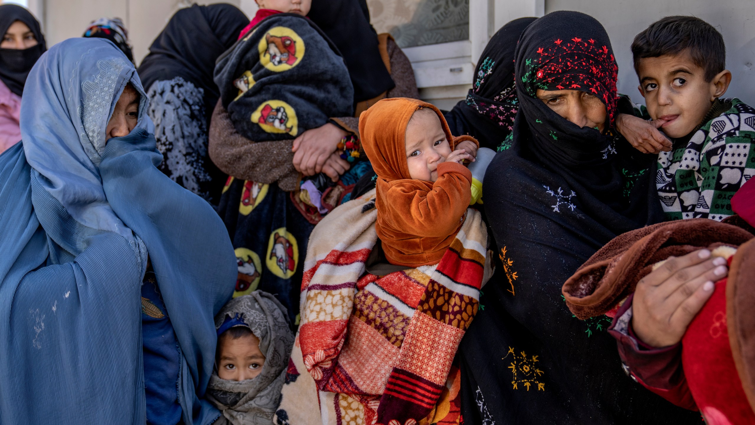 FILE - Mothers along with babies who suffer from malnutrition wait to receive help and check-up at a clinic that run by the WFP, in Kabul, Afghanistan, Thursday, Jan. 26, 2023. (AP Photo/Ebrahim Noroozi, File)