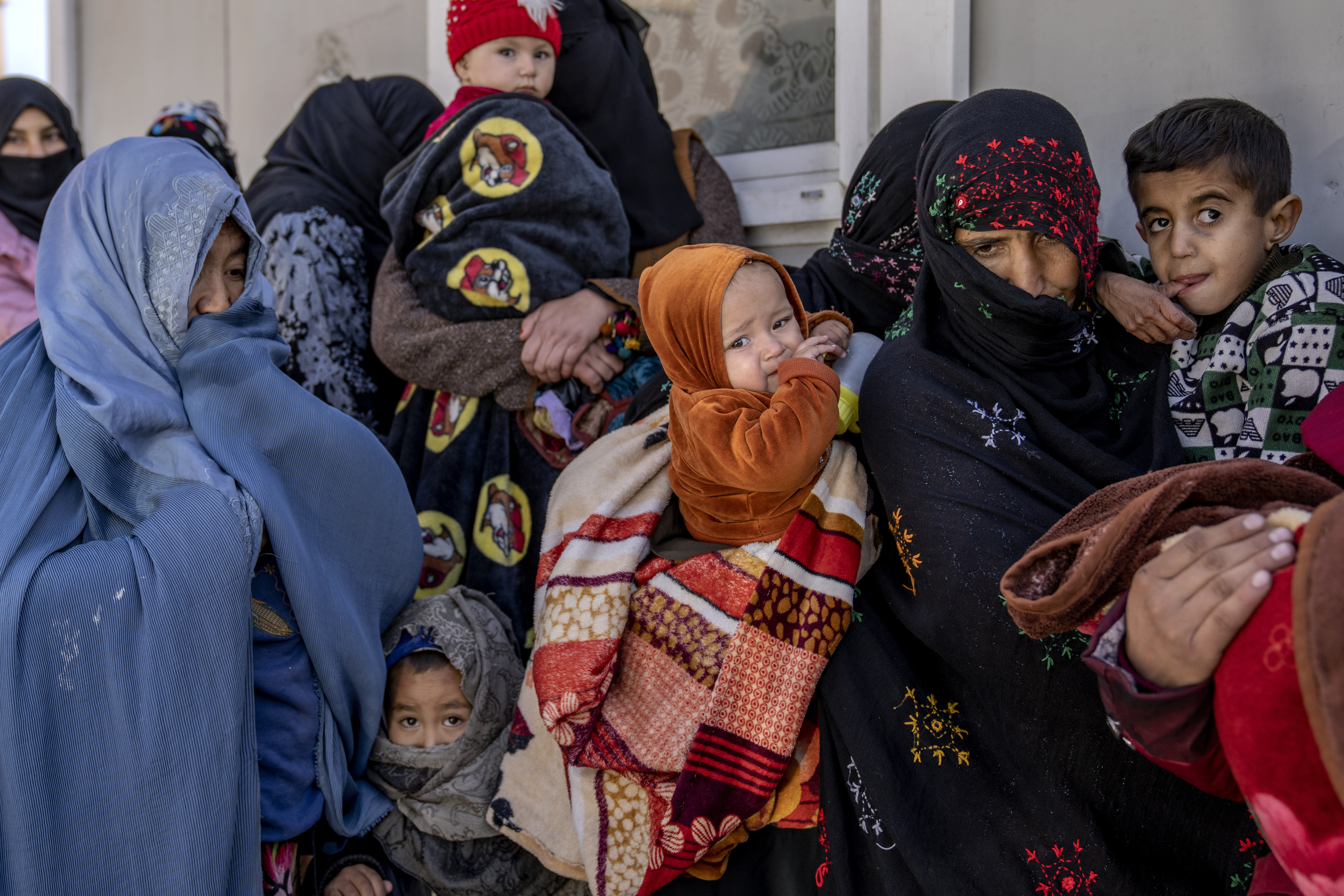 FILE - Mothers along with babies who suffer from malnutrition wait to receive help and check-up at a clinic that run by the WFP, in Kabul, Afghanistan, Thursday, Jan. 26, 2023. (AP Photo/Ebrahim Noroozi, File)