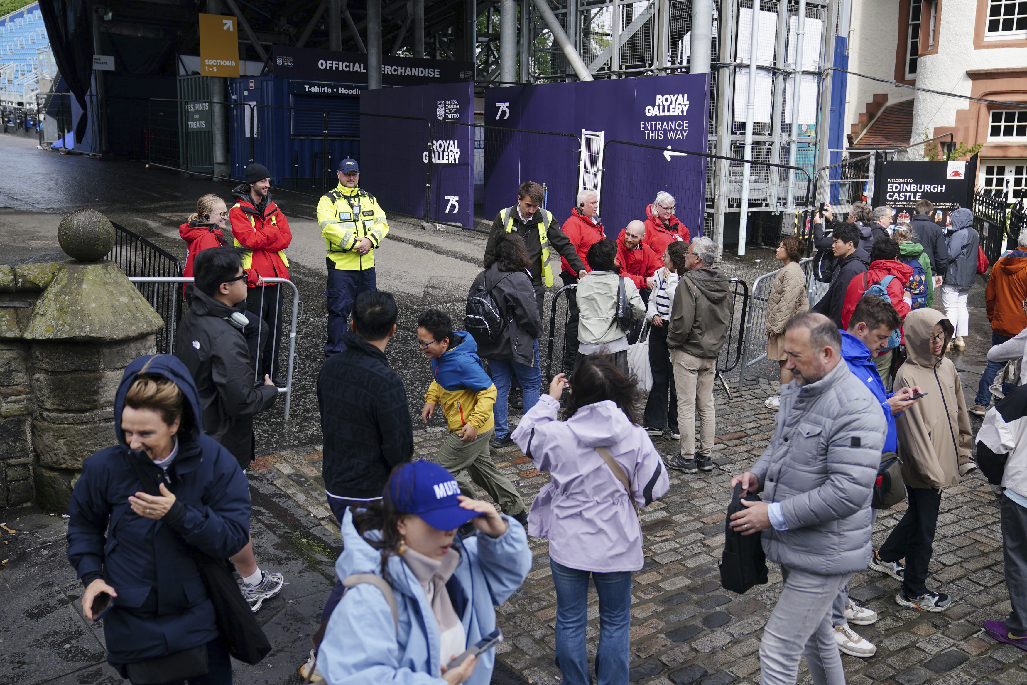 Members of the public are turned away from Edinburgh Castle as the site is closed to visitors due to high winds, in Scotland, Monday Aug. 4, 2025, as weather warnings are coming into force with Storm Floris expected to cause severe travel disruption to road, air and ferry services, and close bridges. (Jane Barlow/PA via AP)