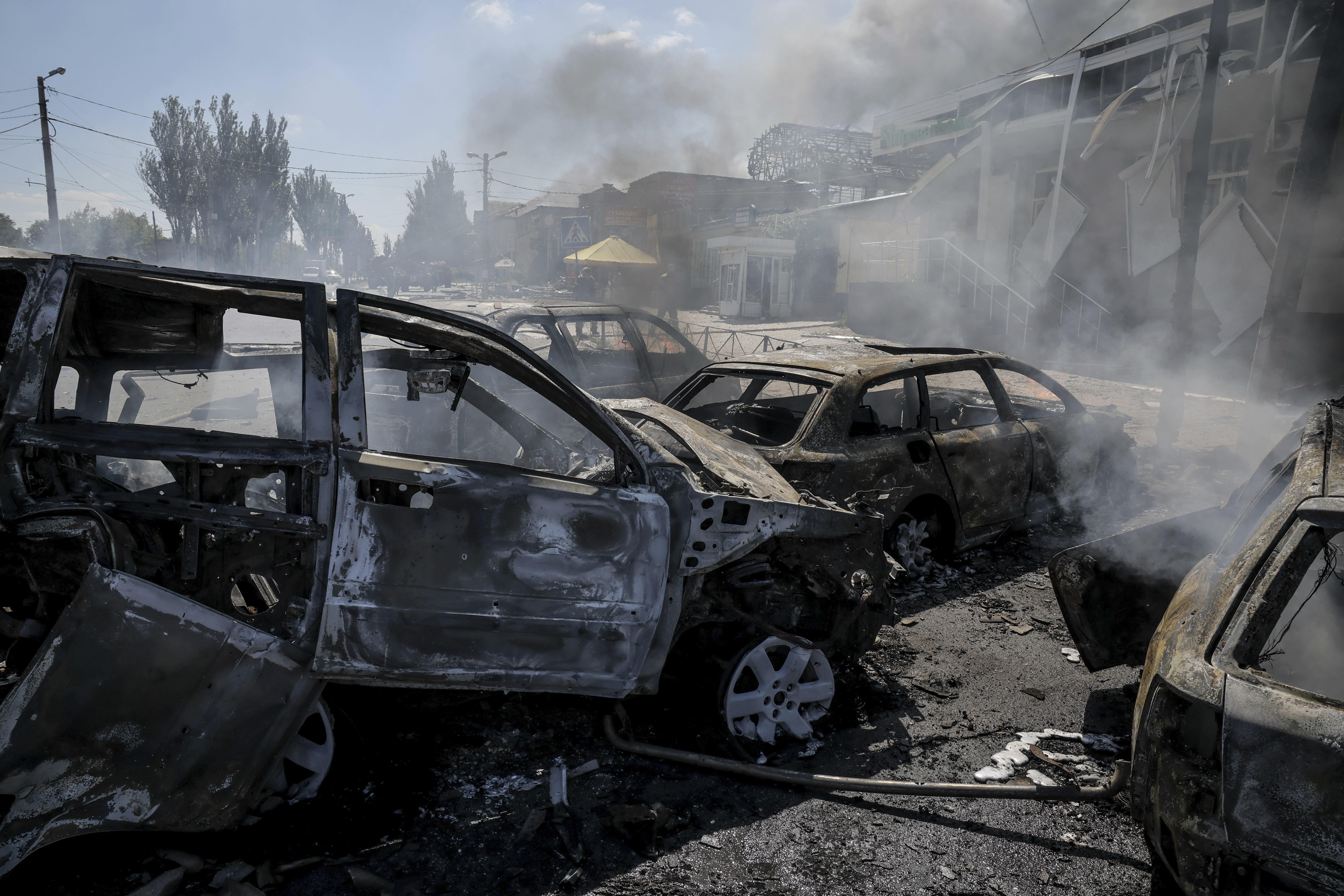 In this photo provided by Ukraine's 24th Mechanized Brigade press service, smoke rises after a Russian drone hit the market in the town of Druzhkivka, Donetsk region, Ukraine, Saturday, Aug. 2, 2025, (Oleg Petrasiuk/Ukraine's 24th Mechanized Brigade via AP)