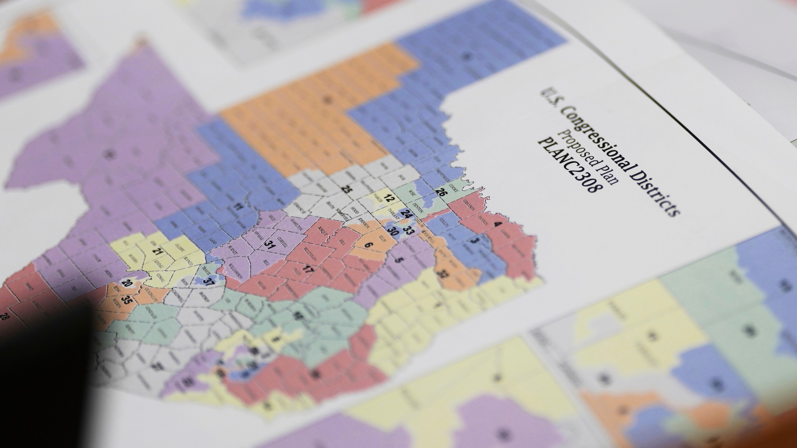 A map of U.S Congressional Districts proposed plan is seen at a Texas legislators' public hearing on congressional redistricting in Austin, Texas, Friday, Aug. 1, 2025. (AP Photo/Eric Gay)