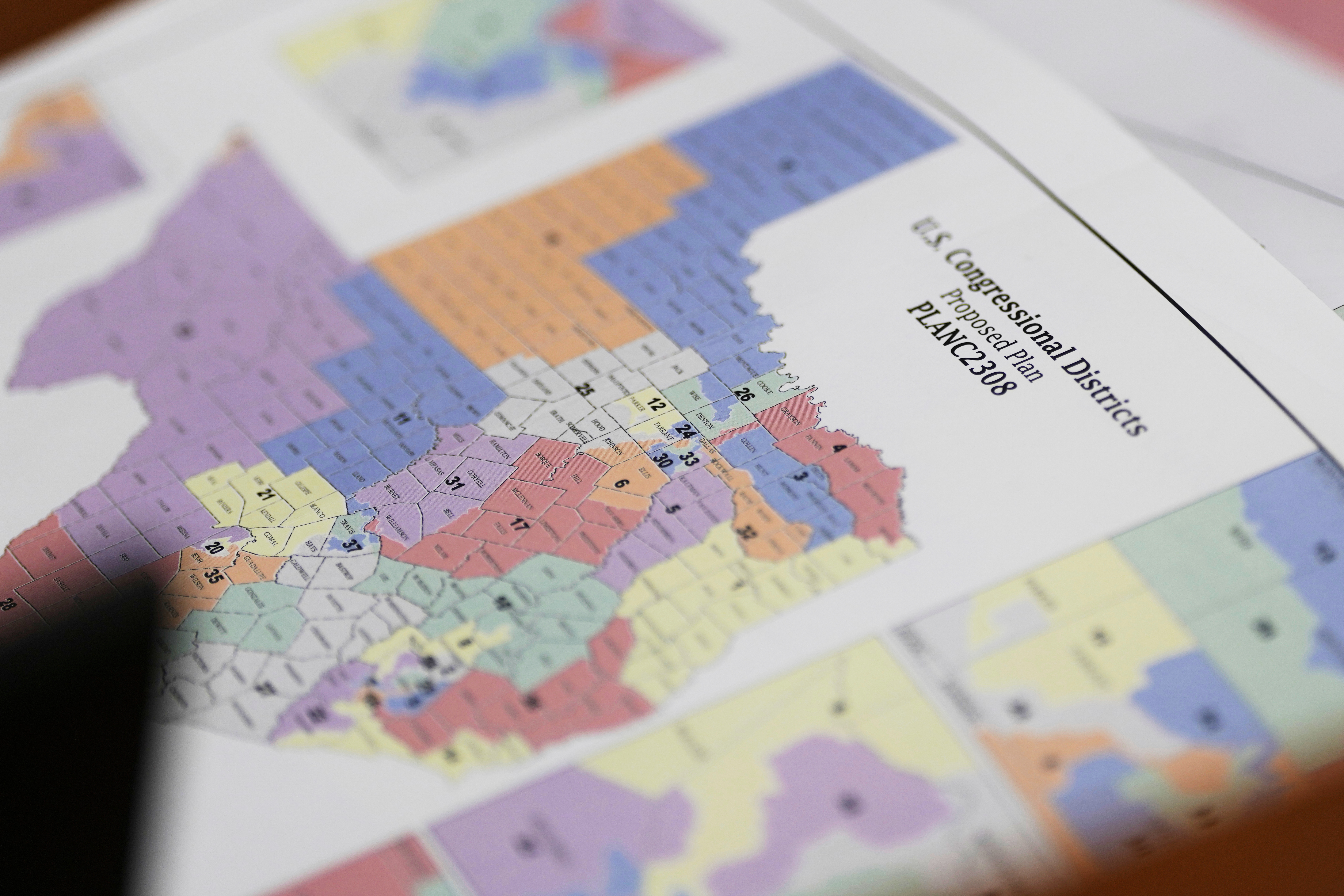 A map of U.S Congressional Districts proposed plan is seen at a Texas legislators' public hearing on congressional redistricting in Austin, Texas, Friday, Aug. 1, 2025. (AP Photo/Eric Gay)