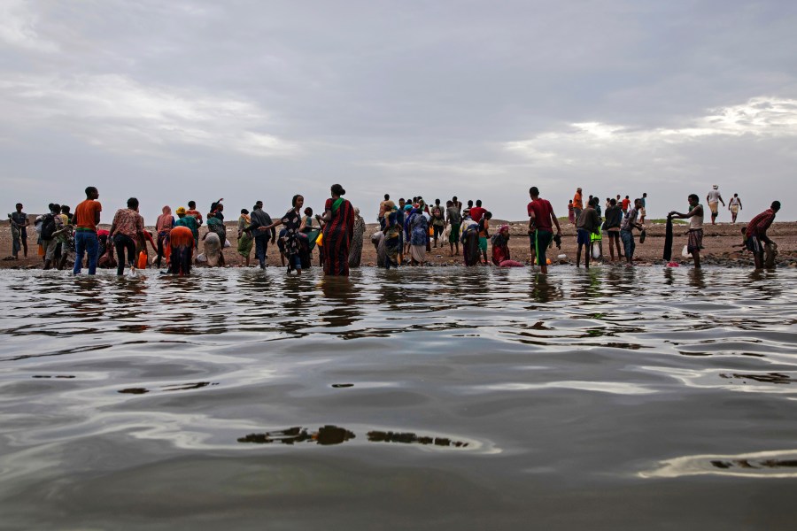 FILE - Ethiopian migrants walk on the shores of Ras al-Ara, Lahj, Yemen, after disembarking from a boat, July 26, 2019. (AP Photo/Nariman El-Mofty, File)