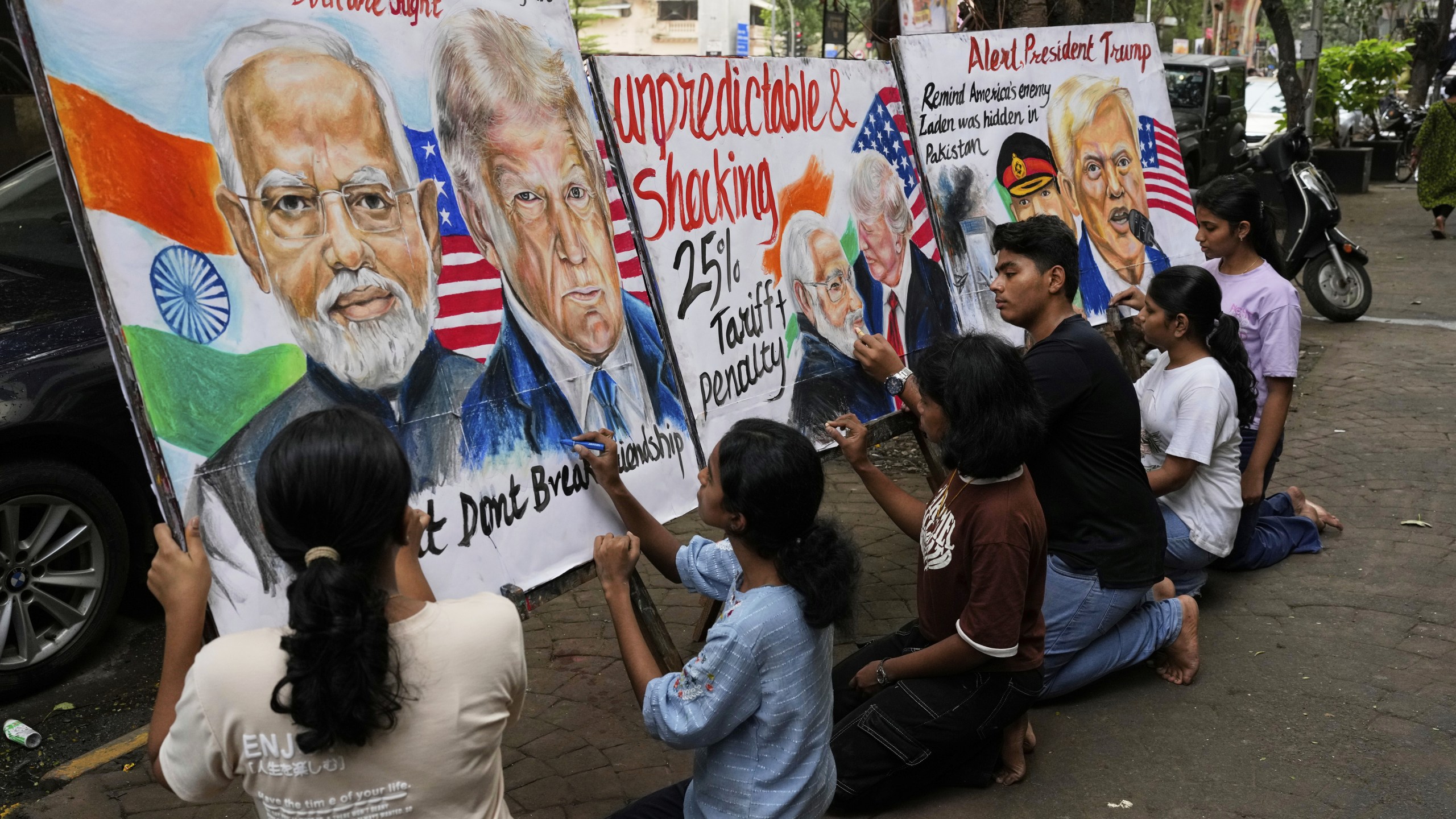 Students of Gurukul school of Art work on paintings of U.S. President Donald Trump and Prime Minister of India Narendra Modi, in Mumbai, India, Friday, Aug. 1, 2025. (AP Photo/Rajanish Kakade)