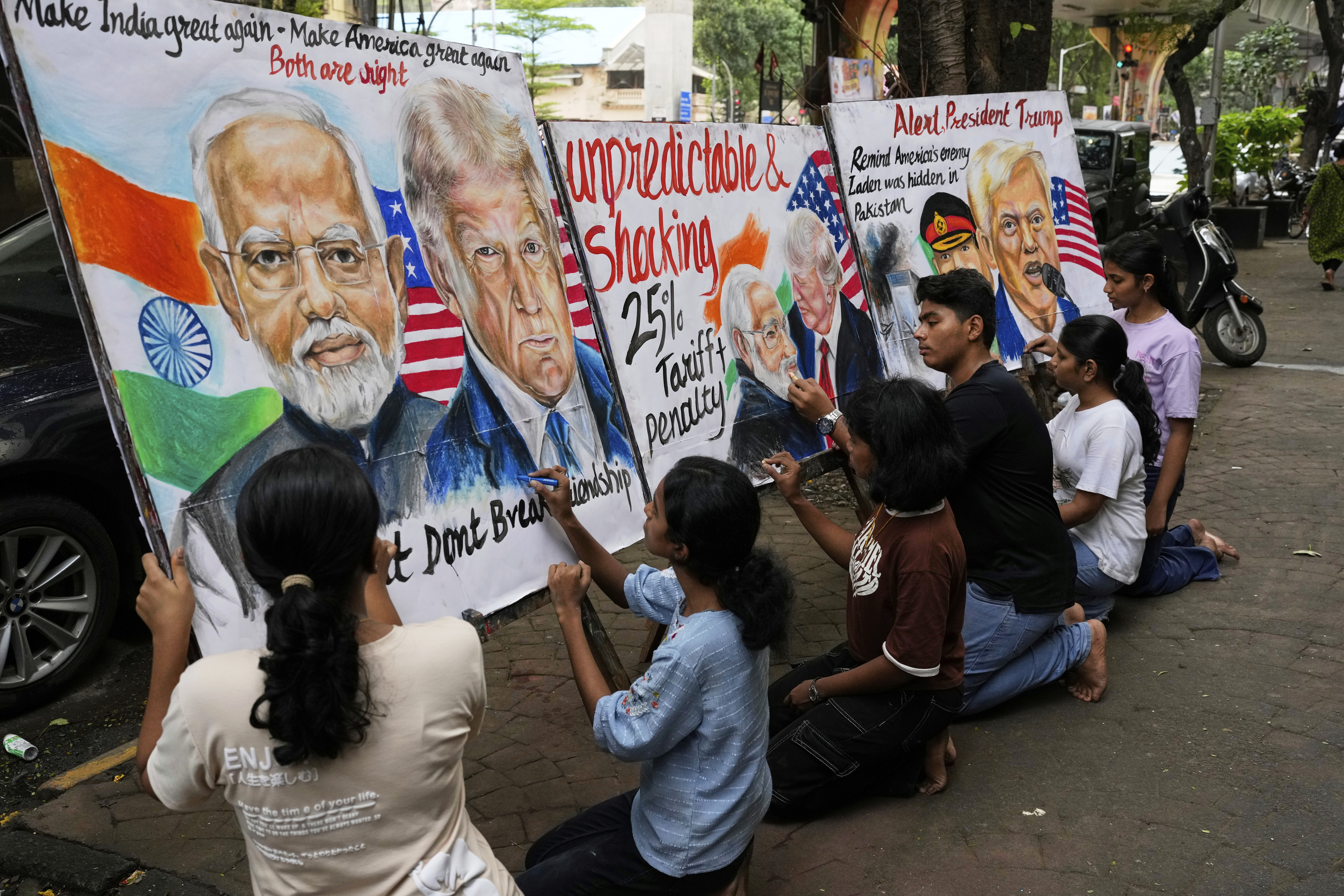Students of Gurukul school of Art work on paintings of U.S. President Donald Trump and Prime Minister of India Narendra Modi, in Mumbai, India, Friday, Aug. 1, 2025. (AP Photo/Rajanish Kakade)