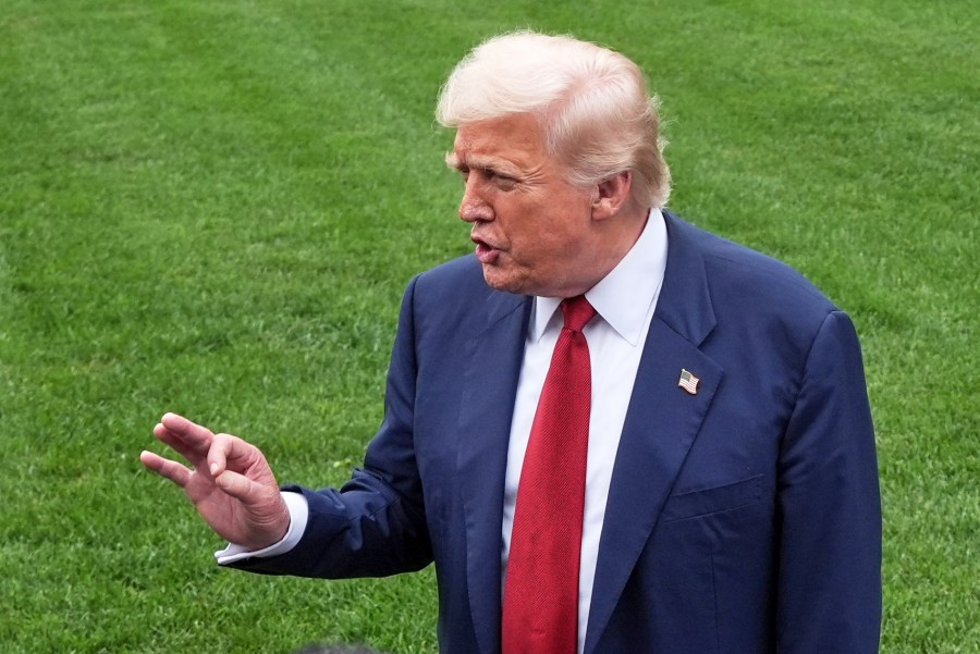President Donald Trump speaks with reporters before walking across the South Lawn of the White House to board Marine One en route to Joint Base Andrews, Md., Friday, Aug. 1, 2025, in Washington. (AP Photo/Jacquelyn Martin)