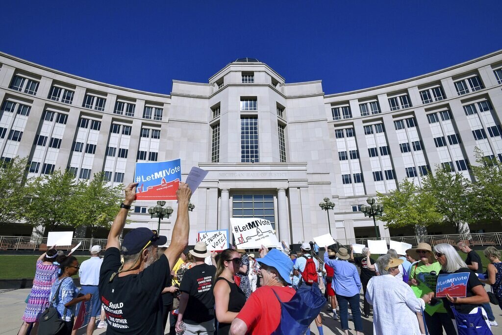FILE - Demonstrators rally outside the Michigan Hall of Justice in Lansing, Mich., on July 18, 2018. (Dale G. Young/Detroit News via AP, File)