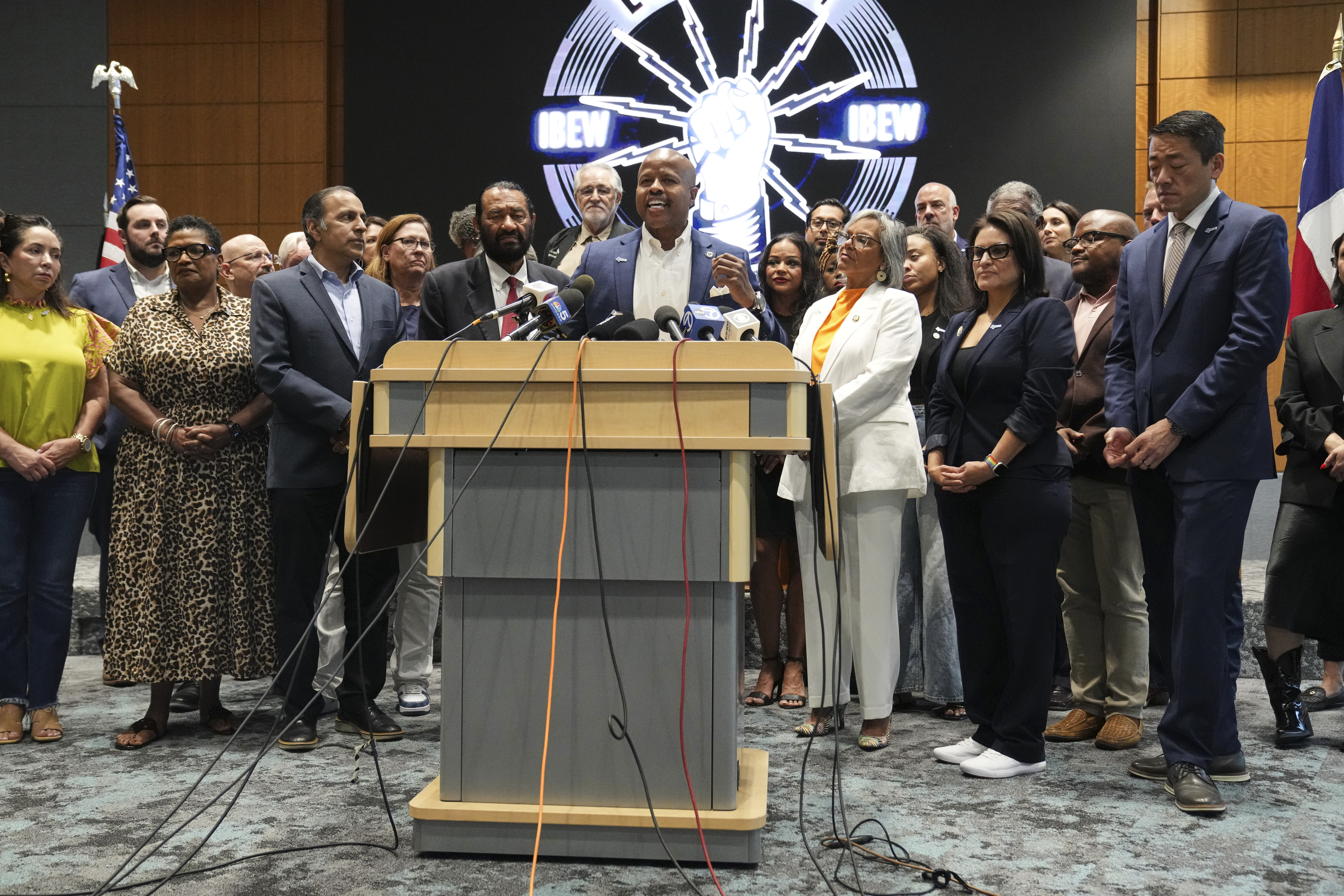 Democratic Texas Rep. Ron Reynolds, center, surrounded by other Texas House Democrats and Democratic members of Congress, speaks during a press conference at the Democratic Party in Warrenville, Ill., Monday, Aug. 4, 2025. (AP Photo/Nam Y. Huh)