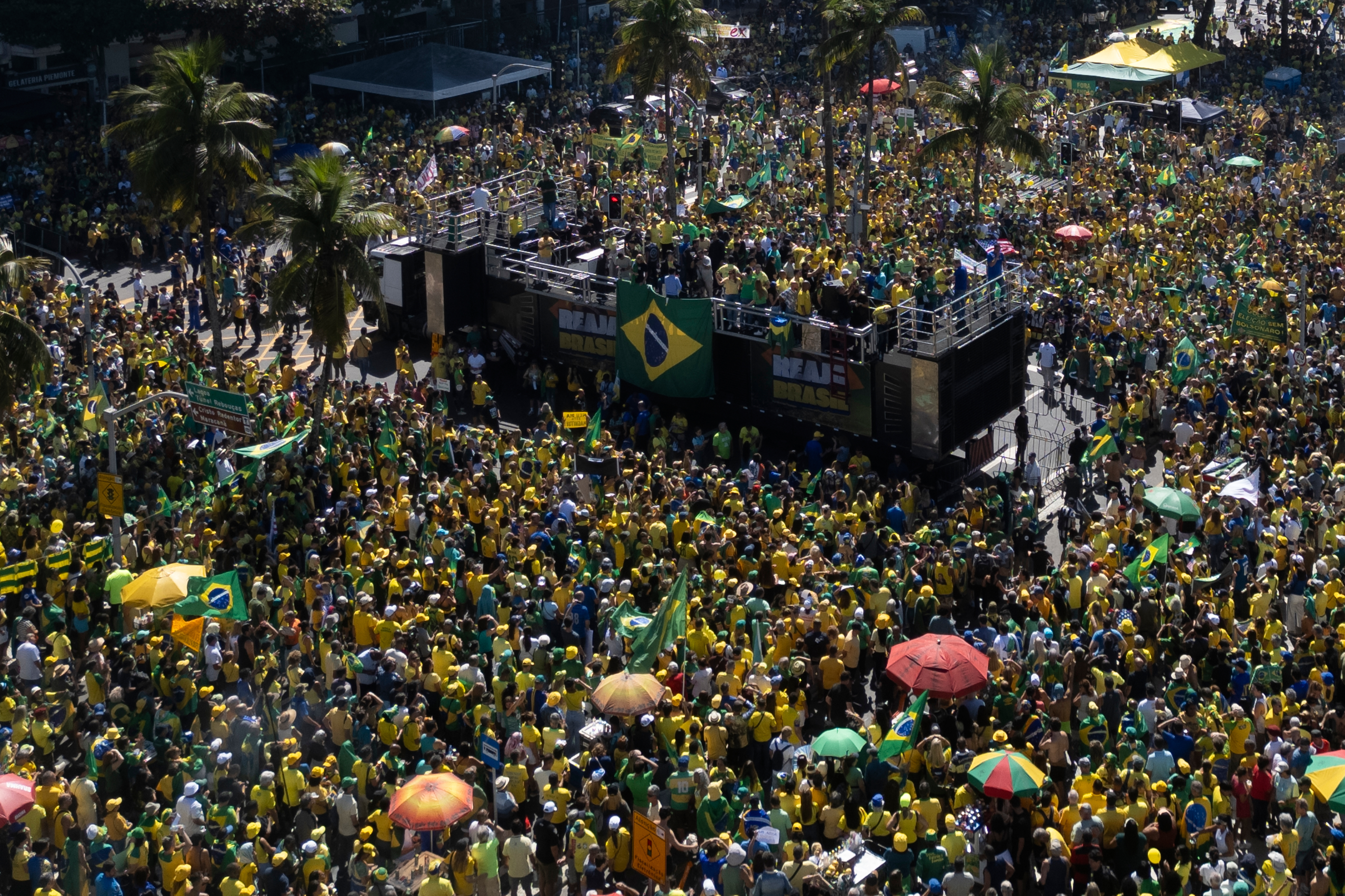 People take part in a demonstration to protest former President Jair Bolsonaro's Supreme Court trial where he faces charges for alleged involvement in a 2022 coup attempt, at Copacabana Beach in Rio de Janeiro, Sunday, Aug. 3, 2025. (AP Photo/Bruna Prado)