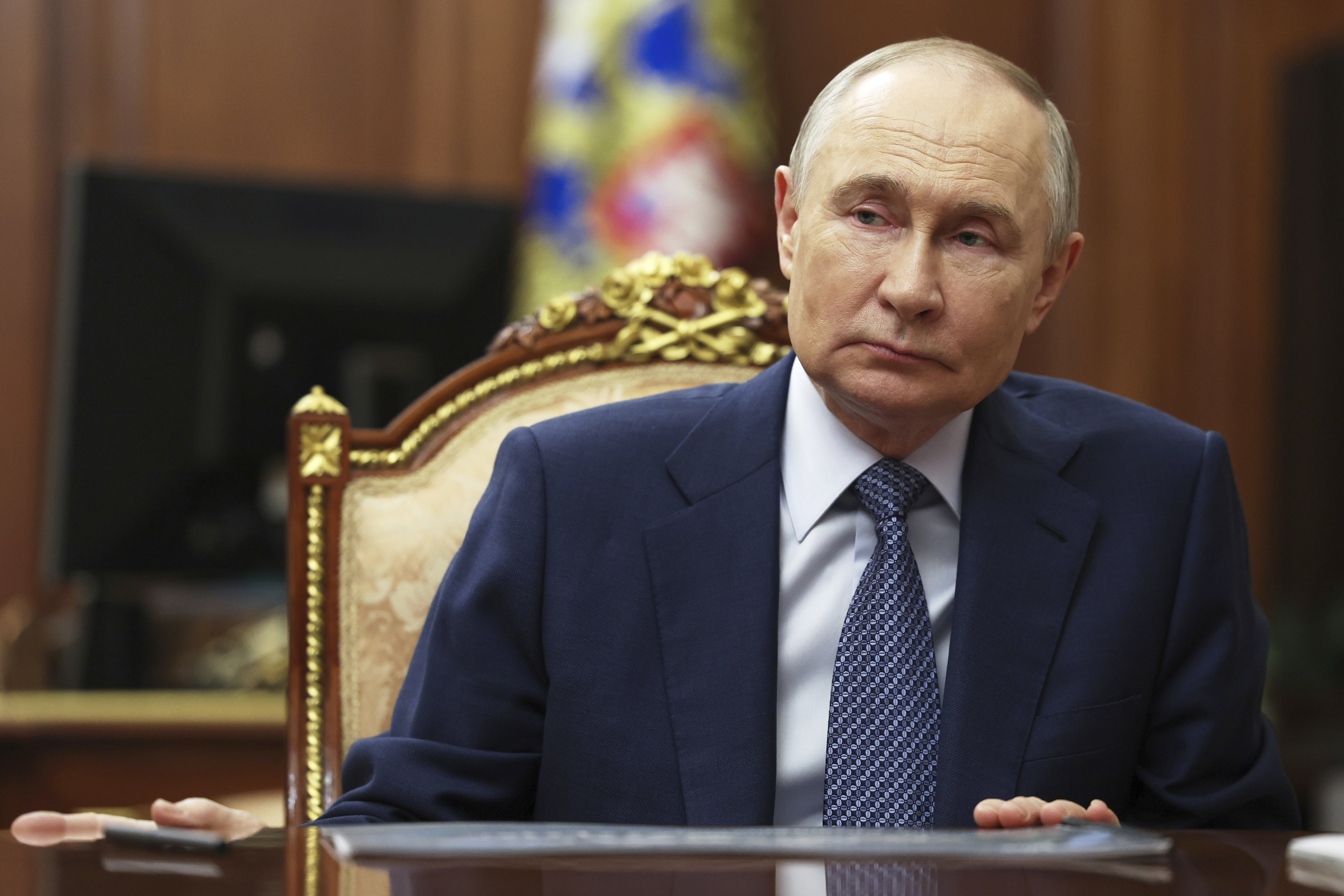 Russian President Vladimir Putin speaks with Sberbank CEO German Gref during their meeting at the Kremlin in Moscow, Russia, Tuesday, July 29, 2025. (Mikhail Metzel, Sputnik, Kremlin Pool Photo via AP)