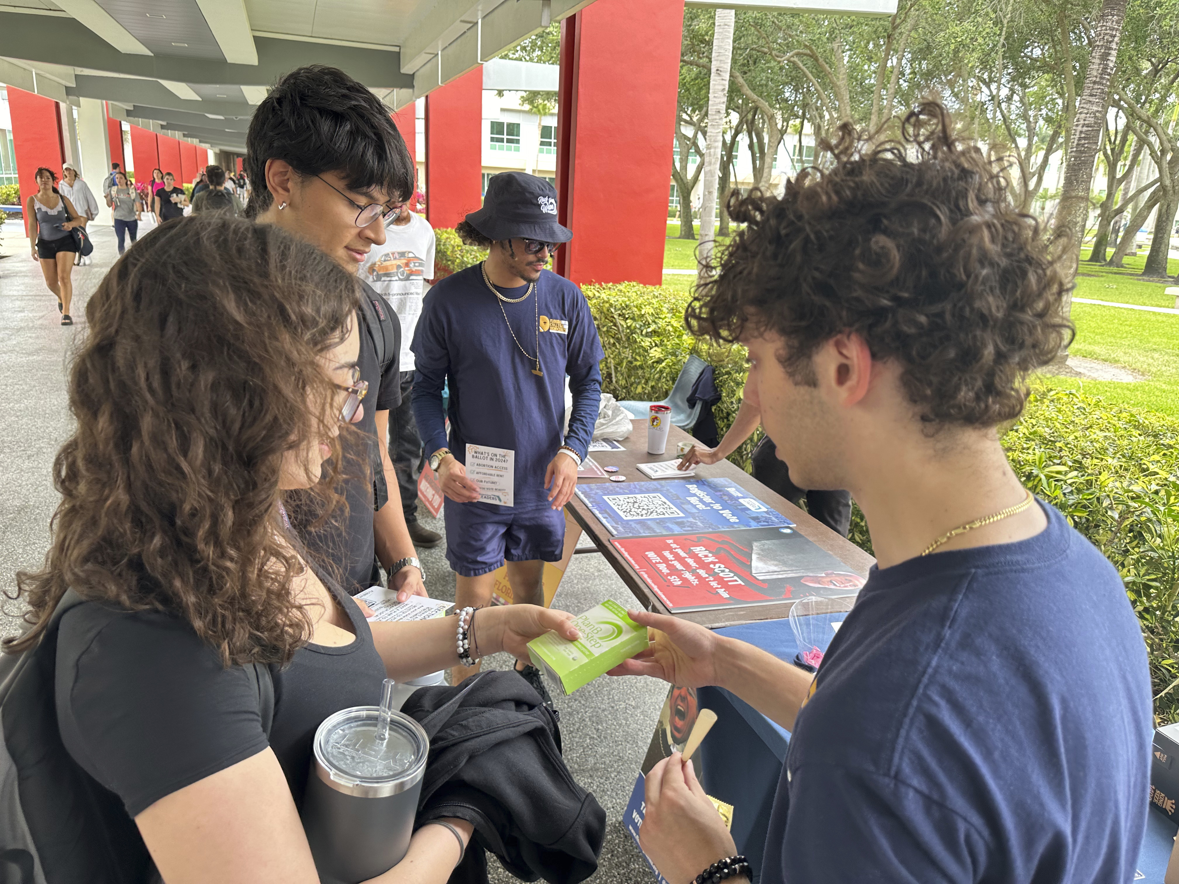 FILE - College students pass out Plan B to educate young voters at Florida Atlantic University April 11, 2024, in Boca Raton, Fla. (AP Photo/Cody Jackson, File)