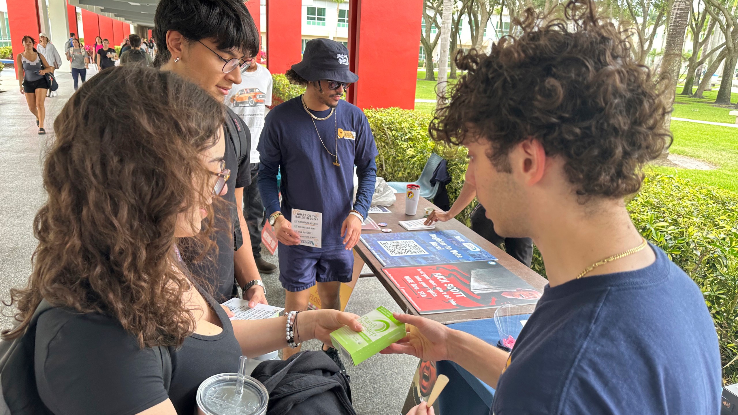 FILE - College students pass out Plan B to educate young voters at Florida Atlantic University April 11, 2024, in Boca Raton, Fla. (AP Photo/Cody Jackson, File)