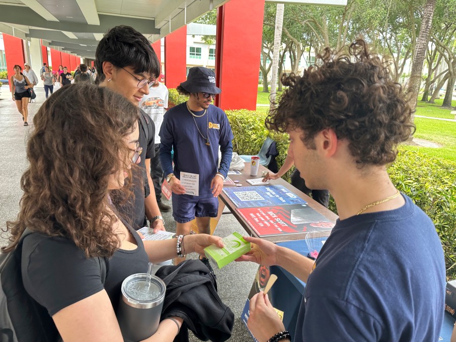 FILE - College students pass out Plan B to educate young voters at Florida Atlantic University April 11, 2024, in Boca Raton, Fla. (AP Photo/Cody Jackson, File)