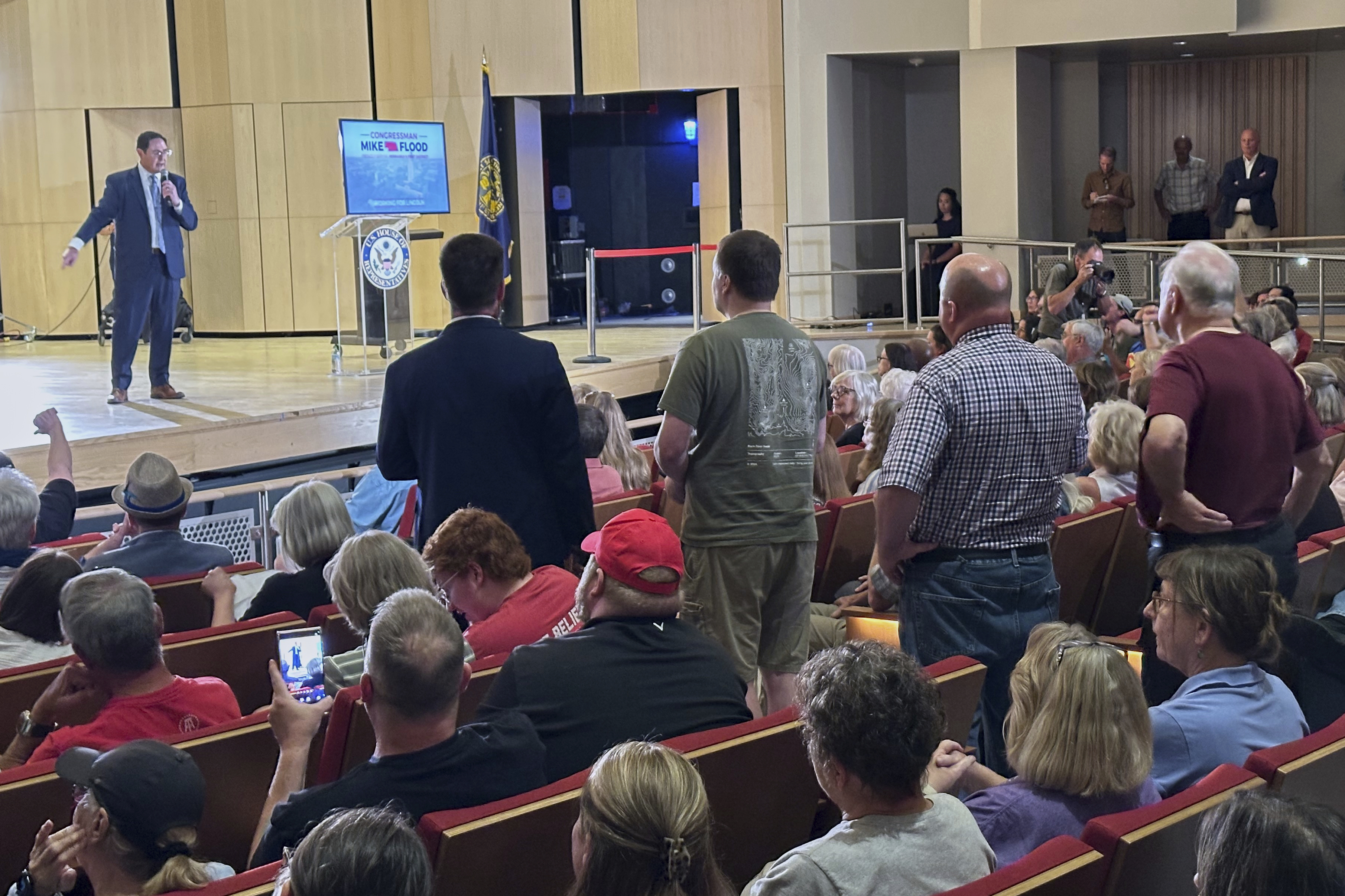 Rep. Mike Flood speaks and takes questions during a town hall meeting on the University of Nebraska campus, Monday, August 5, 2025 in Lincoln, Neb. The second-term Republican braved a Democratic-heavy audience of roughly 700, most of whom booed and chanted in opposition to the GOP-backed tax-break and spending-cut bill President Donald Trump signed last month. (AP Photo/Thomas Beaumont)