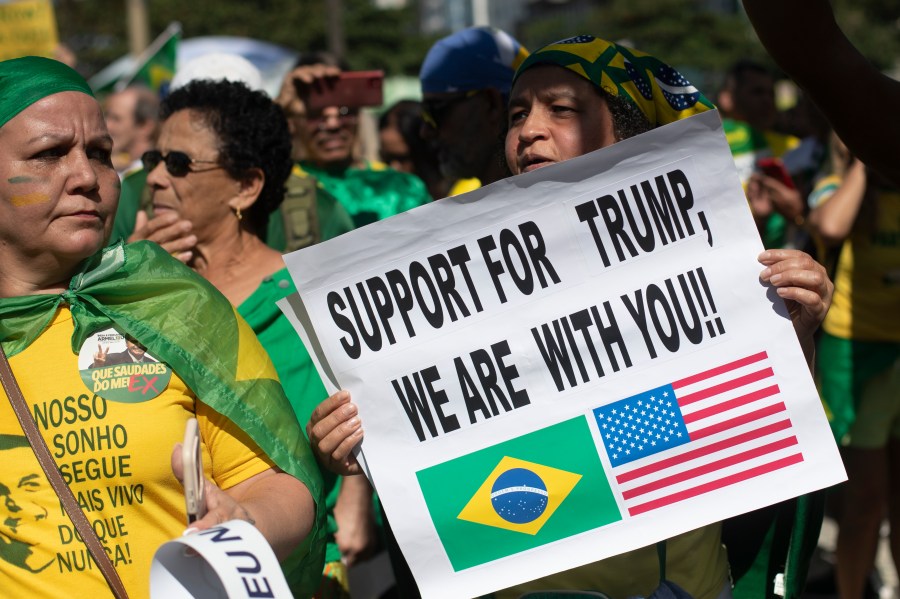 People take part in a demonstration to protest former President Jair Bolsonaro's Supreme Court trial where he faces charges for alleged involvement in a 2022 coup attempt, at Copacabana Beach in Rio de Janeiro, Sunday, Aug. 3, 2025. (AP Photo/Bruna Prado)