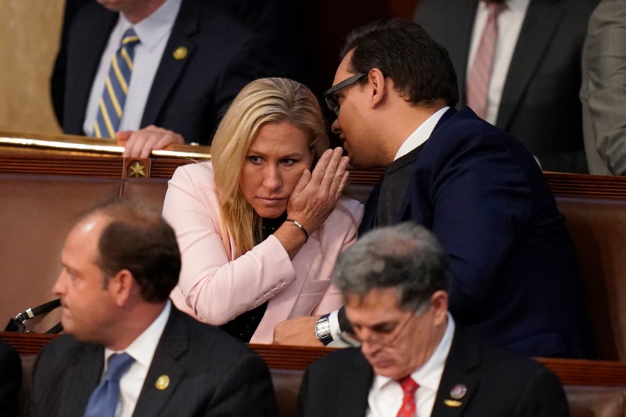 FILE - Rep.-elect George Santos, R-N.Y., right, talks with Rep. Marjorie Taylor Greene, R-Ga., during the ninth vote in the House chamber as the House meets for the third day to elect a speaker and convene the 118th Congress in Washington, Thursday, Jan. 5, 2023. (AP Photo/Alex Brandon, File)