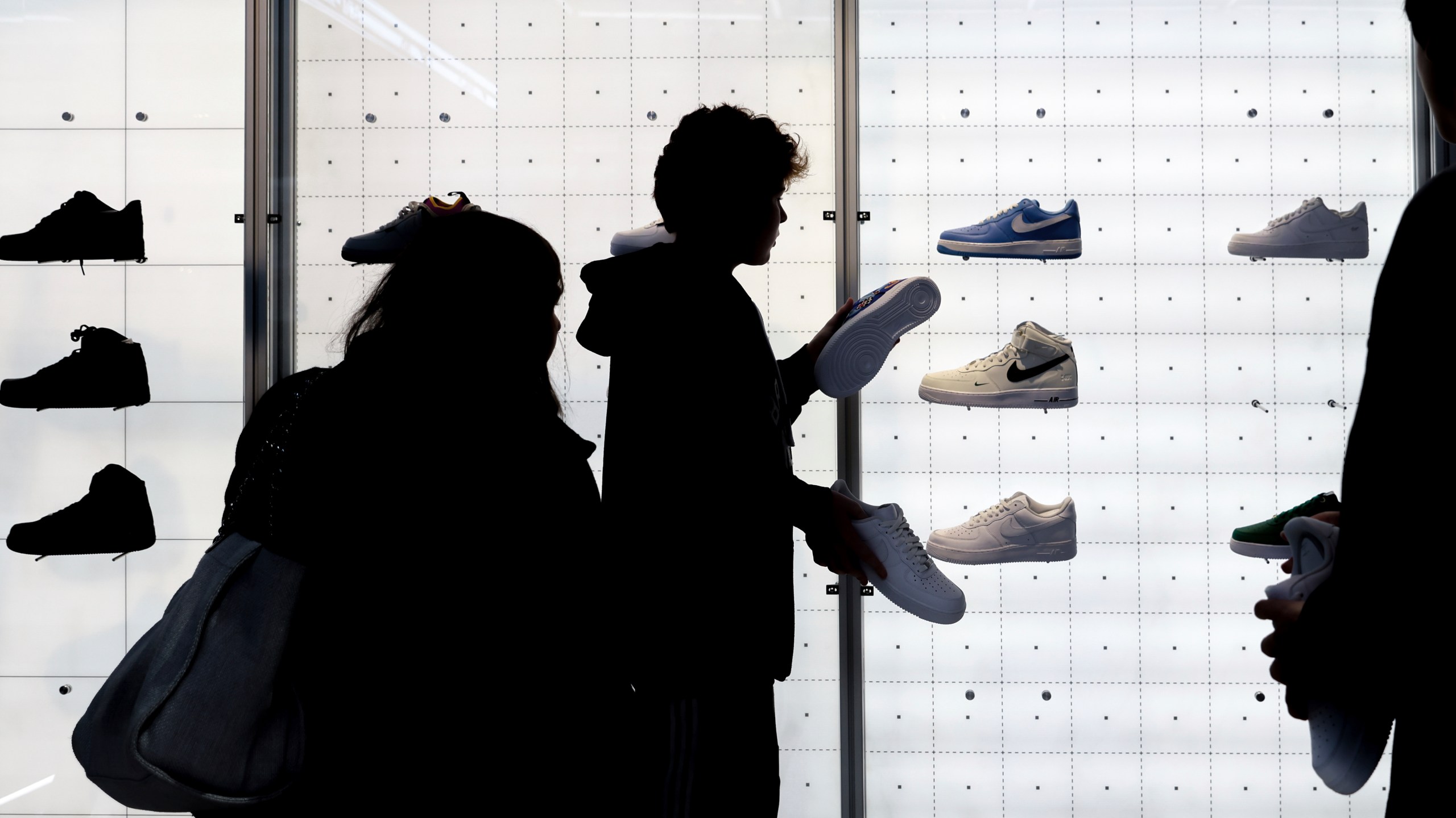 FILE - People shop for shoes on , Nov. 25, 2022, in New York. (AP Photo/Julia Nikhinson, File)