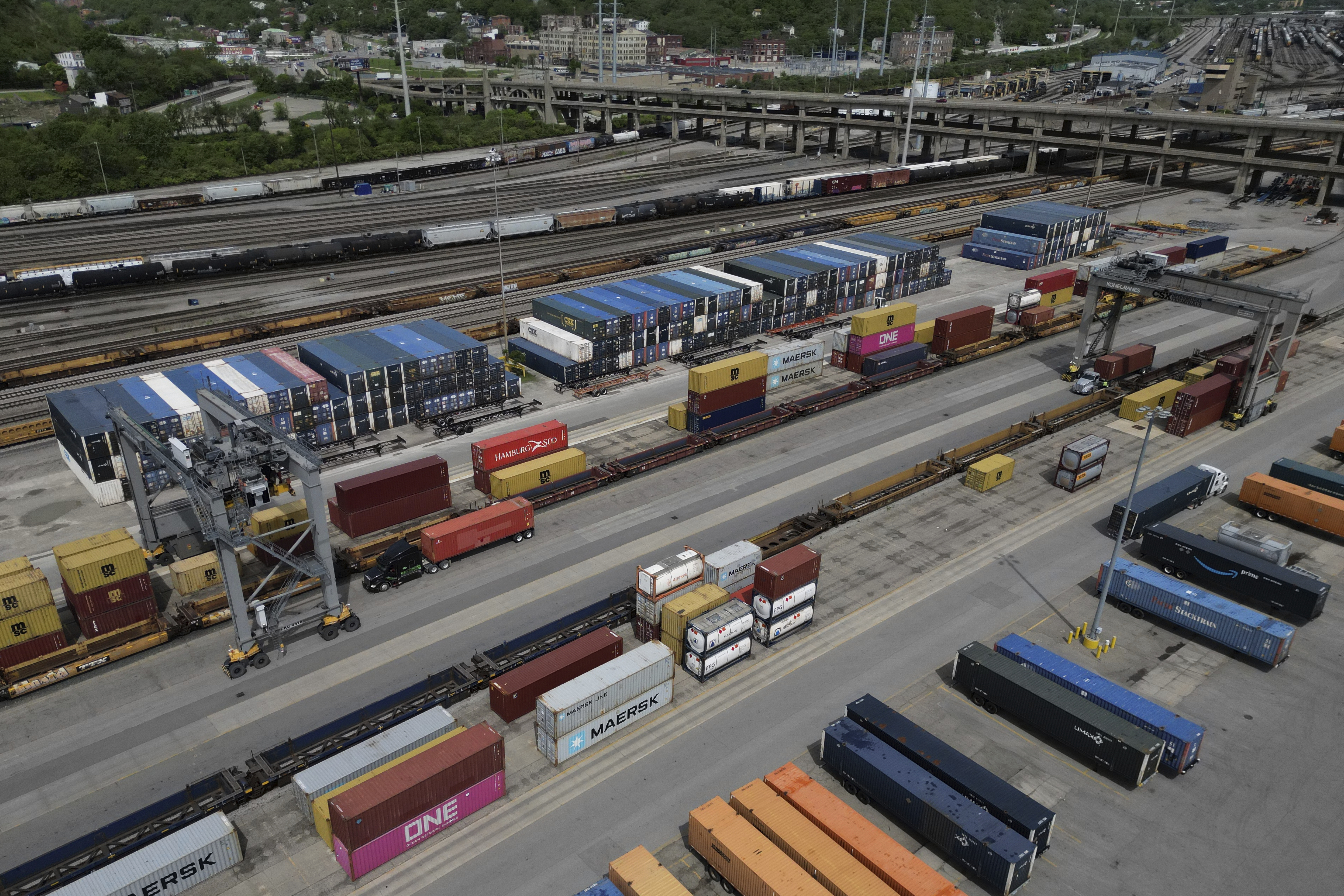 FILE - Shipping containers are loaded onto trucks at CSX Intermodal Terminals, a supplier of rail-based freight transportation, at CSX Queensgate Rail Yard, May 7, 2025, in Cincinnati. (AP Photo/Carolyn Kaster, File)