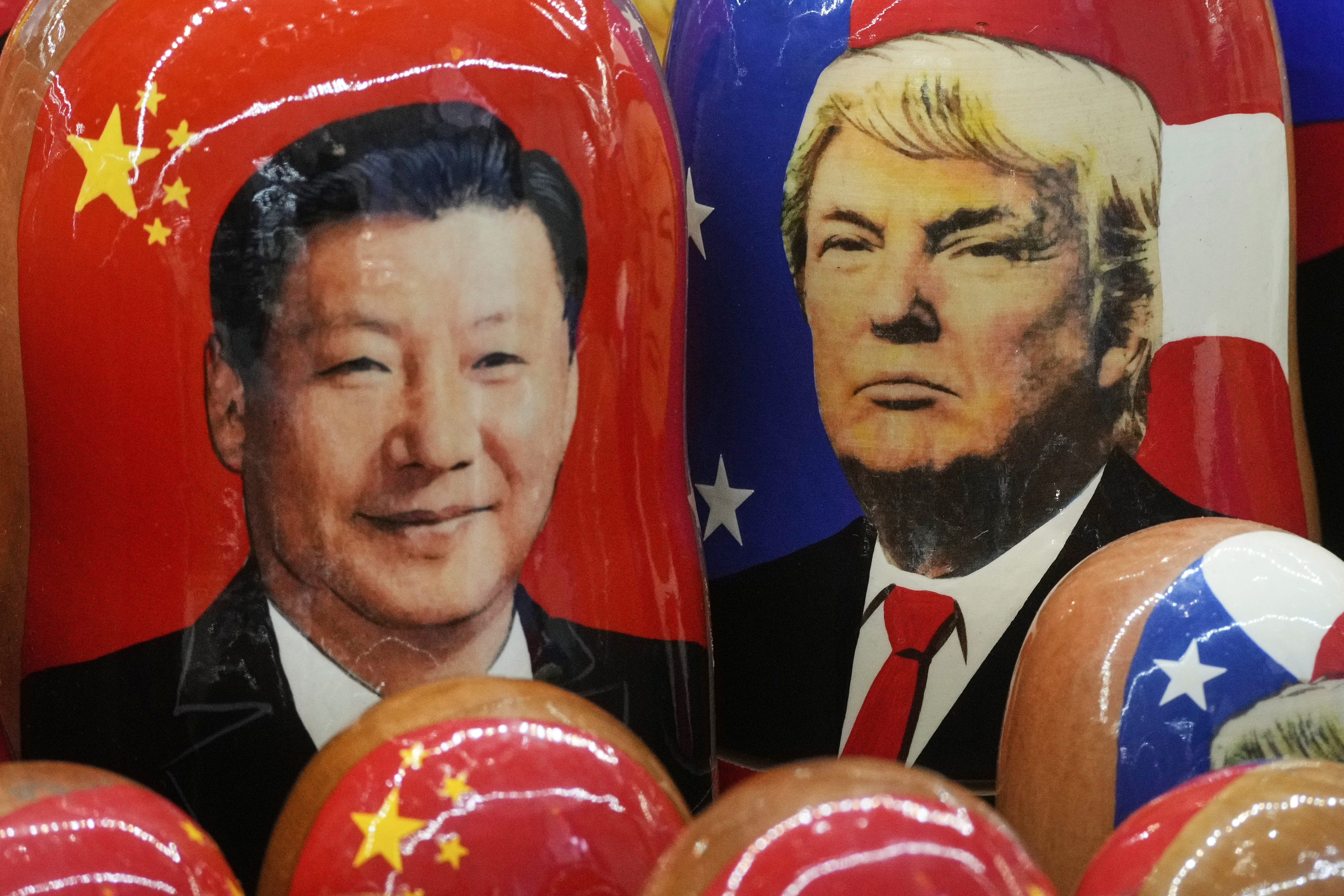 FILE - Traditional Russian wooden dolls called Matryoshka depicting China's President Xi Jinping and President Donald Trump at a souvenir shop in St. Petersburg, Russia, Nov. 21, 2024. (AP Photo/Dmitri Lovetsky, File)