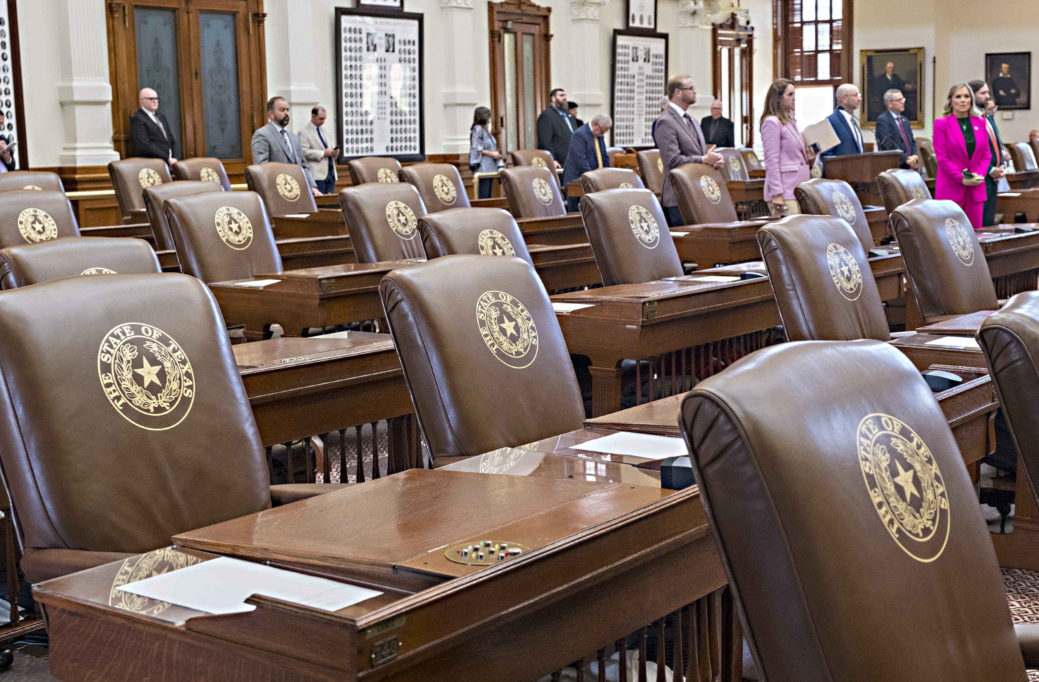 Empty chairs belonging to House Democrats remain empty during a session convocation in the State Capitol, Tuesday, Aug. 5, 2025, in Austin, Texas. (AP Photo/Rodolfo Gonzalez)