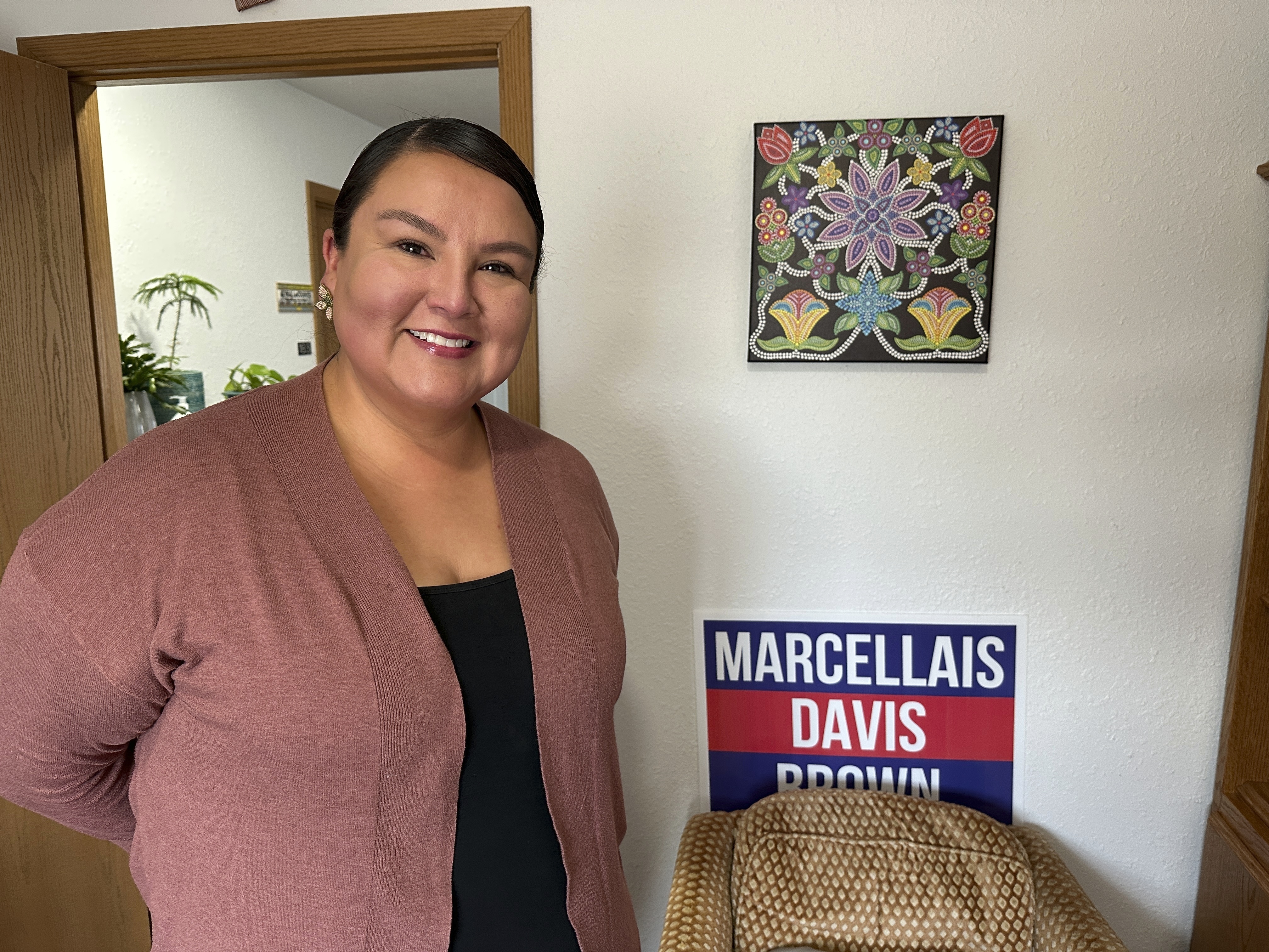 North Dakota Democratic Rep. Jayme Davis poses for a photo in her office with a 2024 campaign sign on Wednesday, July 23, 2025, at Turtle Mountain Administrative Offices on the Turtle Mountain Reservation in North Dakota. (AP Photo/Jack Dura)
