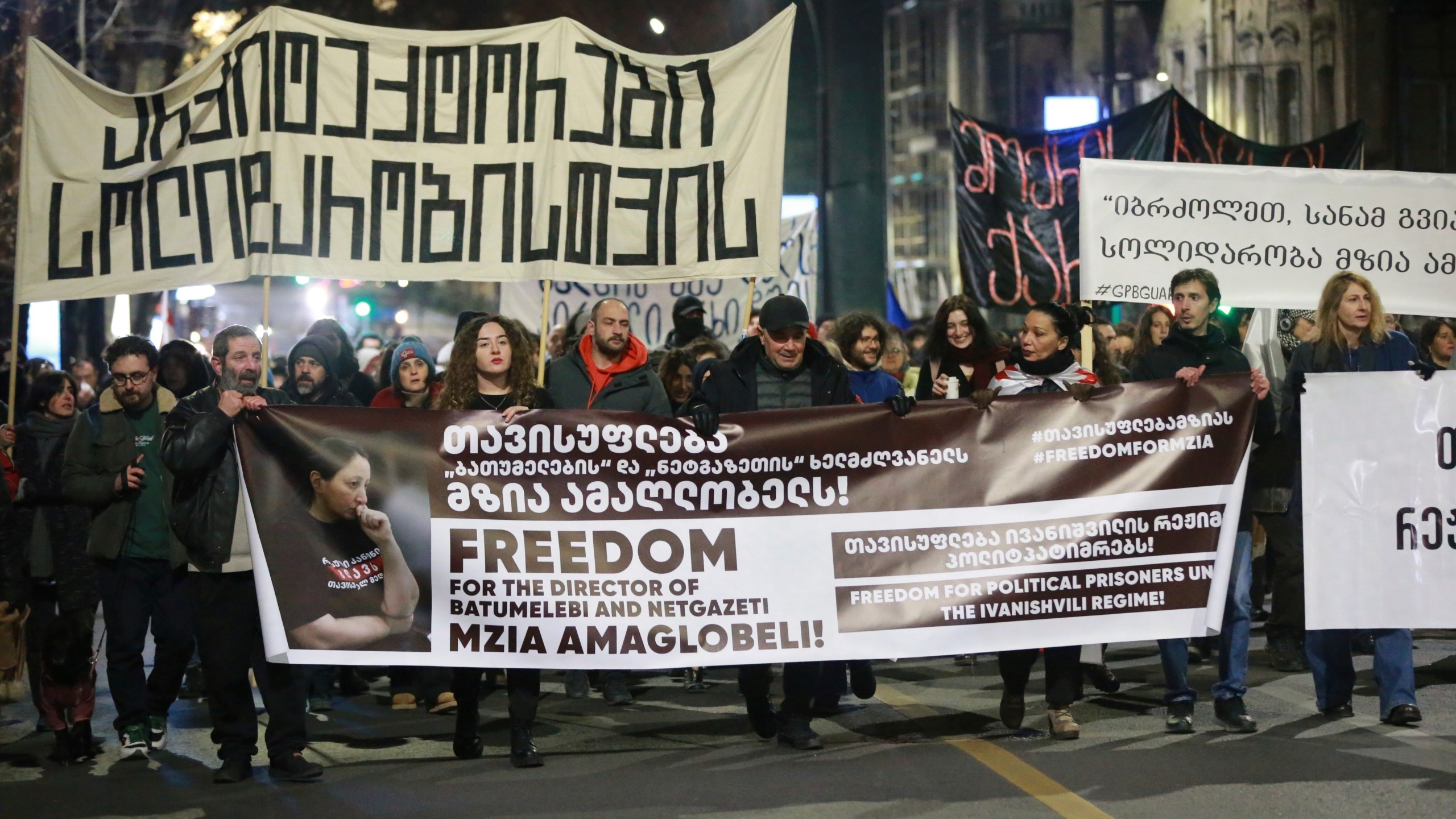 FILE - Protesters hold banners calling for the release of jailed journalist Mzia Amaghlobeli as they march through the streets in Tbilisi, Georgia, on Wednesday, Jan. 29, 2025. (AP Photo/Zurab Tsertsvadze, File)