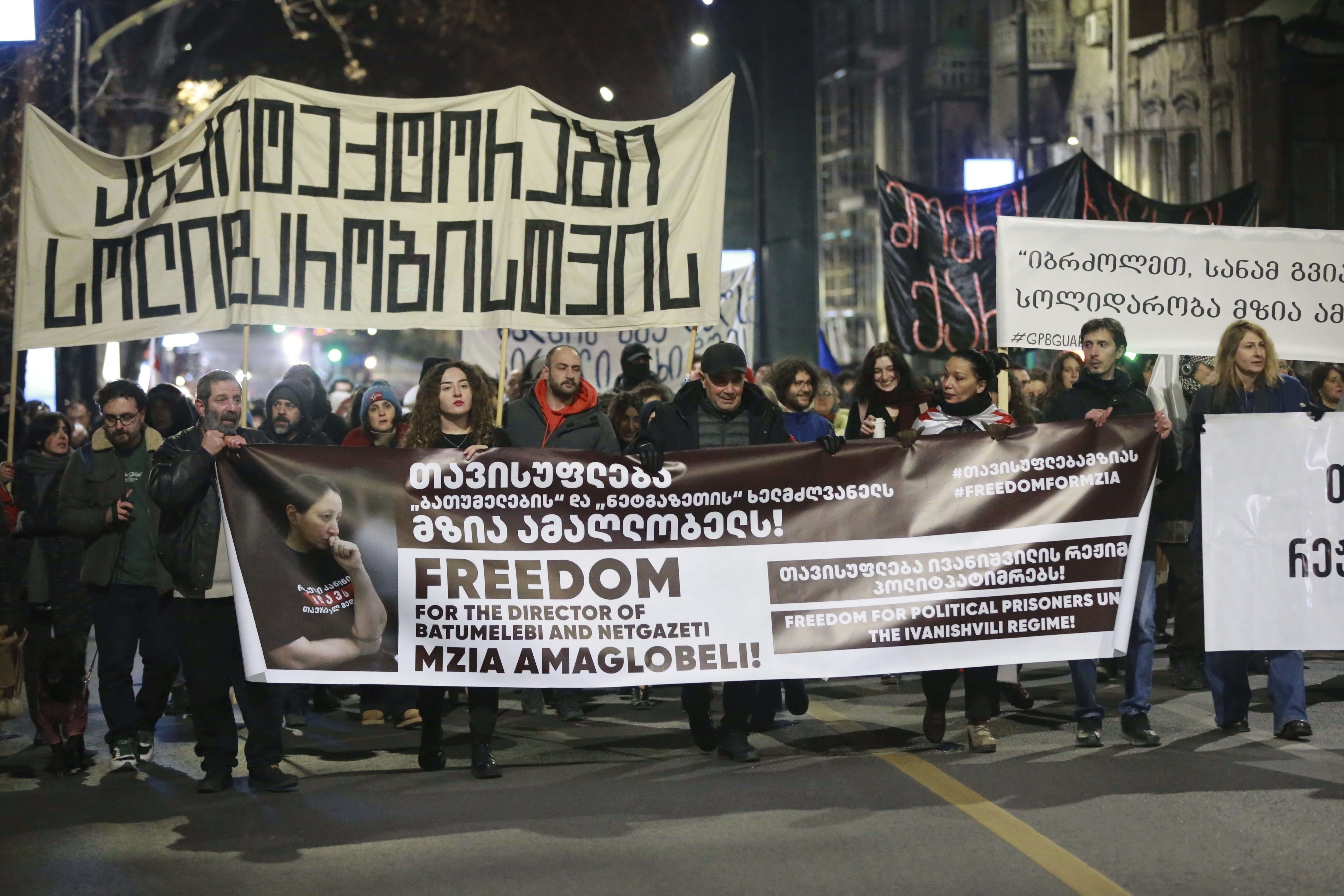 FILE - Protesters hold banners calling for the release of jailed journalist Mzia Amaghlobeli as they march through the streets in Tbilisi, Georgia, on Wednesday, Jan. 29, 2025. (AP Photo/Zurab Tsertsvadze, File)