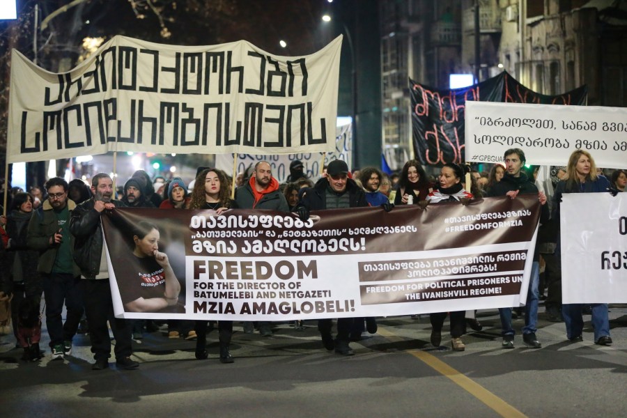 FILE - Protesters hold banners calling for the release of jailed journalist Mzia Amaghlobeli as they march through the streets in Tbilisi, Georgia, on Wednesday, Jan. 29, 2025. (AP Photo/Zurab Tsertsvadze, File)
