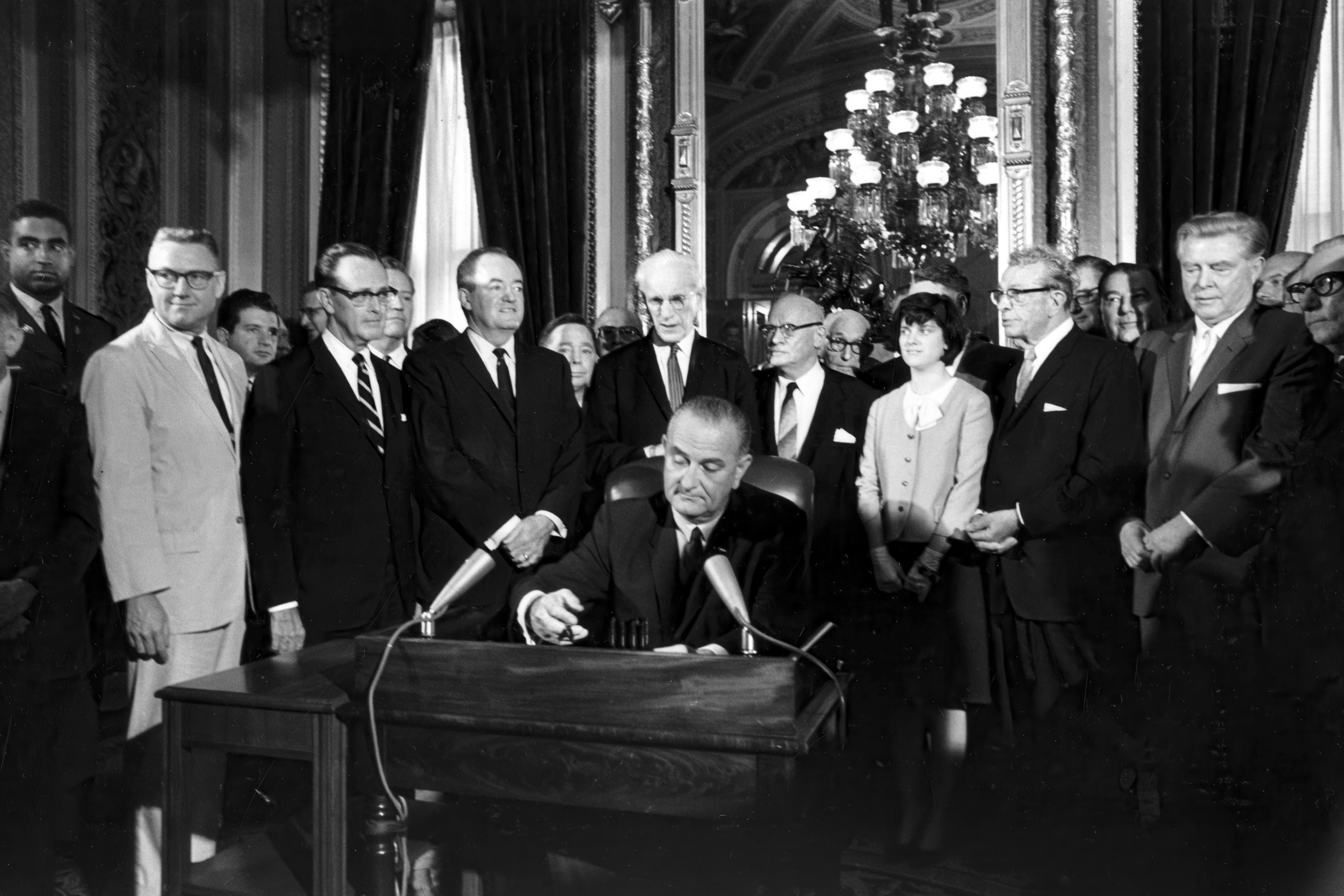 FILE - President Lyndon B. Johnson signs the Voting Rights Act of 1965 in a ceremony in the President's Room near the Senate chambers in Washington, Aug. 6, 1965. Surrounding the president from left directly above his right hand, Vice President Hubert Humphrey; Speaker John McCormack; Rep. Emanuel Celler, D-N.Y.; Luci Johnson; and Sen. Everett Dirksen, R-Ill. Behind Humphrey is House Majority Leader Carl Albert of Oklahoma; and behind Celler is Sen. Carl Hayden, D-Ariz. (AP Photo, File)