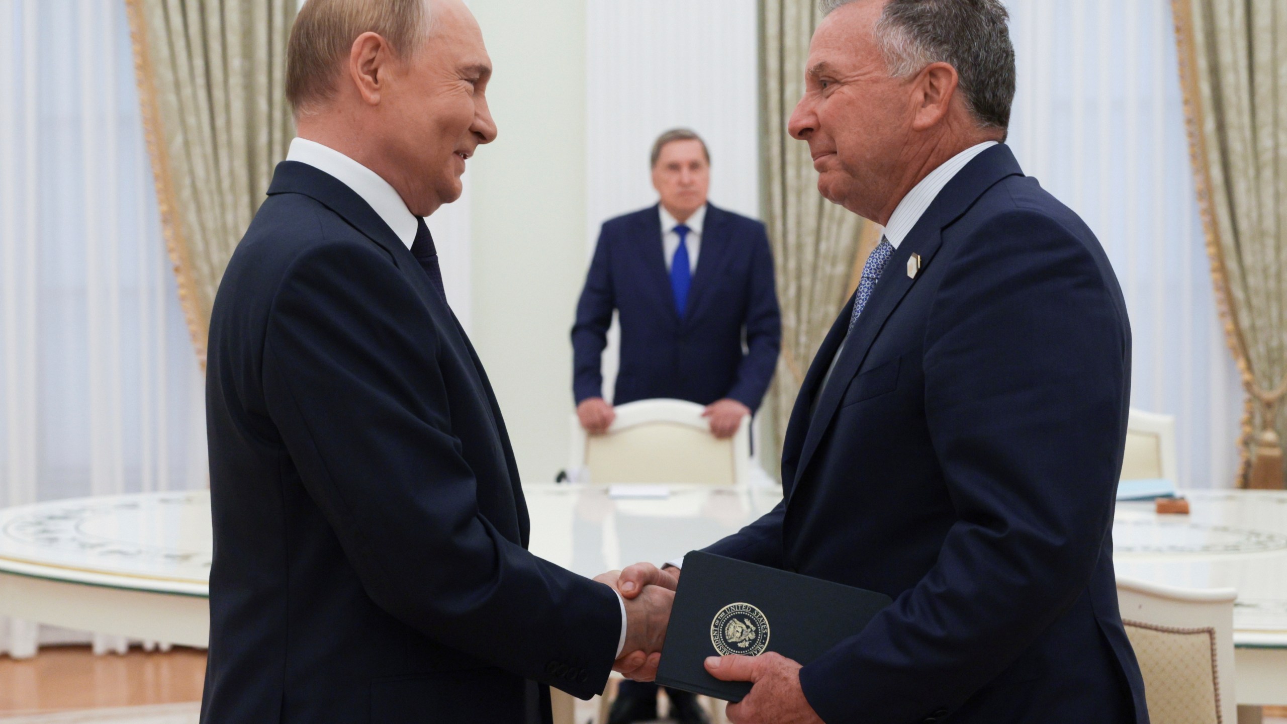 Russian President Vladimir Putin, left, and U.S. President Donald Trump's special envoy Steve Witkoff, right, shake hands during their meeting in Moscow, Russia, Wednesday, Aug. 6, 2025. (Gavriil Grigorov, Sputnik, Kremlin Pool Photo via AP)