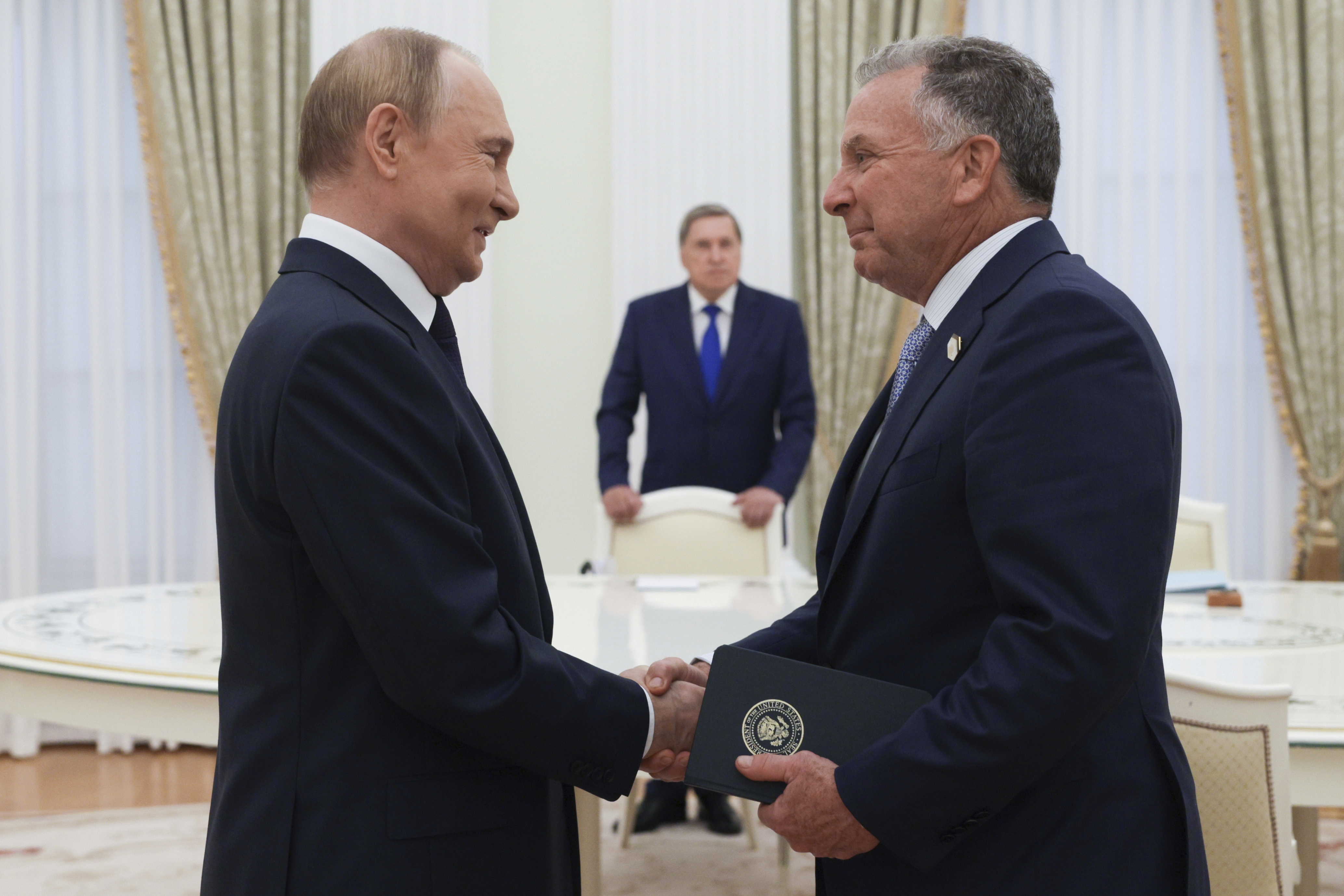 Russian President Vladimir Putin, left, and U.S. President Donald Trump's special envoy Steve Witkoff, right, shake hands during their meeting in Moscow, Russia, Wednesday, Aug. 6, 2025. (Gavriil Grigorov, Sputnik, Kremlin Pool Photo via AP)