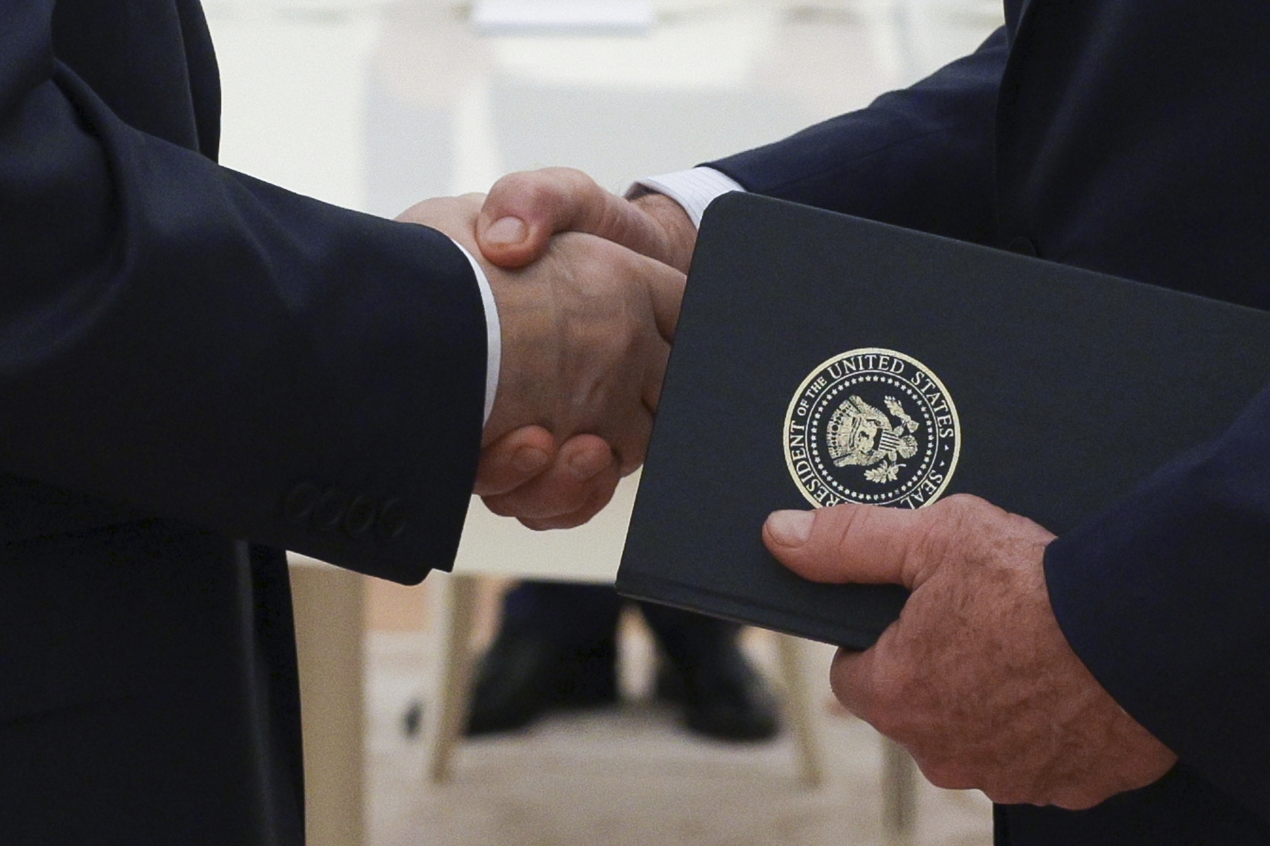 Russian President Vladimir Putin, left, and U.S. President Donald Trump's special envoy Steve Witkoff, right, shake hands during their meeting at the Kremlin in Moscow, Russia, Wednesday, Aug. 6, 2025. (Gavriil Grigorov, Sputnik, Kremlin Pool Photo via AP)