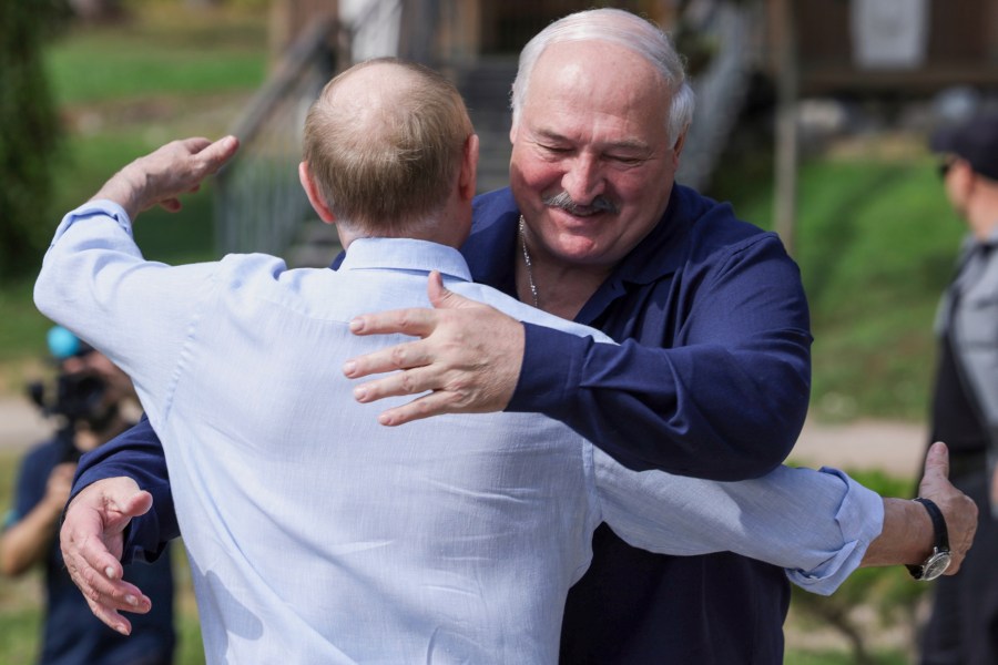 Russian President Vladimir Putin, front, embraces Belarusian President Alexander Lukashenko during their visit to the Smolensky Skete of Valaam Monastery at Valaam island in Ladoga lake, Republic of Karelia, Russia, Friday, Aug. 1, 2025. (Gavriil Grigorov, Sputnik, Kremlin Pool Photo via AP)