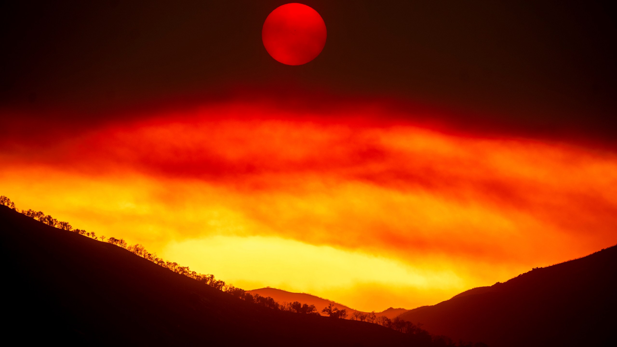 Smoke from the Gifford Fire fills the sky as the sun sets over Los Padres National Forest, Calif., on Monday, Aug. 4, 2025. (AP Photo/Noah Berger)