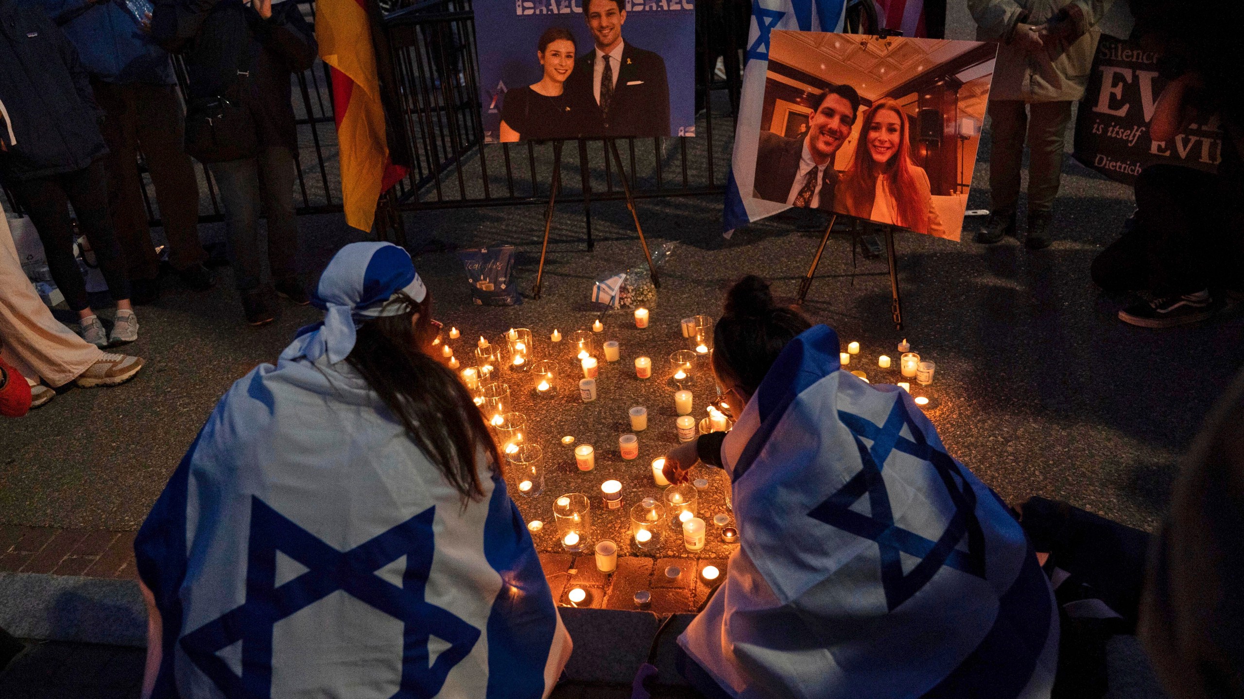 FILE - People gather to light candles in a makeshift memorial to honor Yaron Lischinsky and Sarah Milgrim who were killed as they left an event at the Capital Jewish Museum in Washington, during a candlelight vigil outside of the White House in Washington, Thursday, May 22, 2025. (AP Photo/Jose Luis Magana, File)