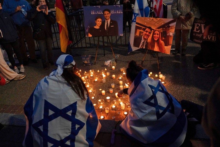 FILE - People gather to light candles in a makeshift memorial to honor Yaron Lischinsky and Sarah Milgrim who were killed as they left an event at the Capital Jewish Museum in Washington, during a candlelight vigil outside of the White House in Washington, Thursday, May 22, 2025. (AP Photo/Jose Luis Magana, File)