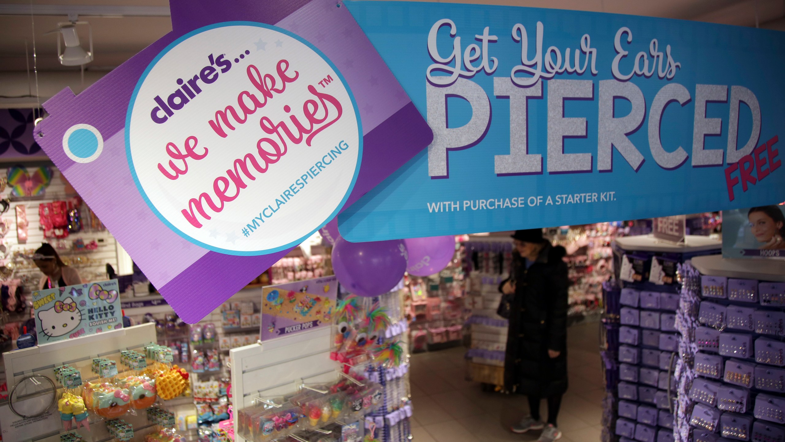 FILE - People shop at a Claire's in New York, Saturday, March 17, 2018. (AP Photo/Seth Wenig, File)