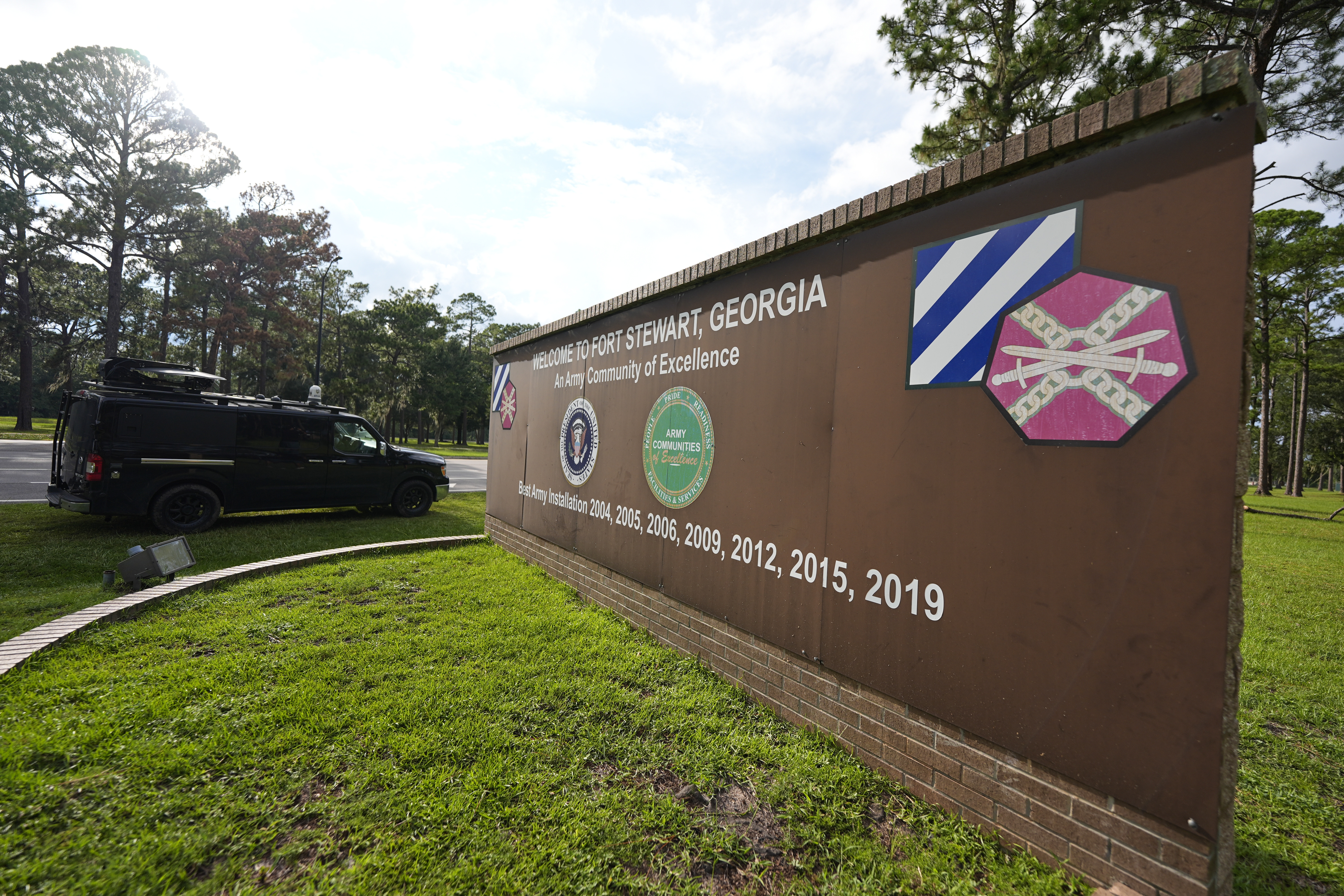A sign welcoming people to Fort Stewart in Georgia is seen on Wednesday, Aug. 6, 2025. (AP Photo/Mike Stewart)