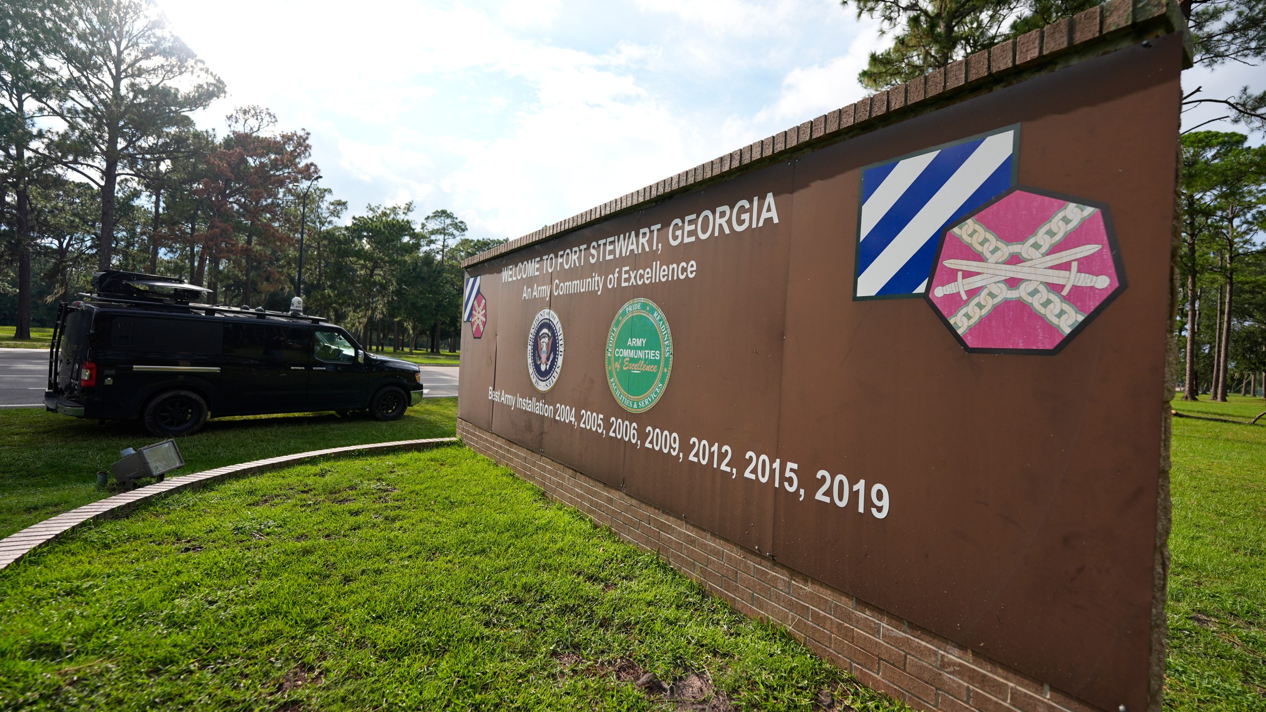 A sign welcoming people to Fort Stewart in Georgia is seen on Wednesday, Aug. 6, 2025. (AP Photo/Mike Stewart)