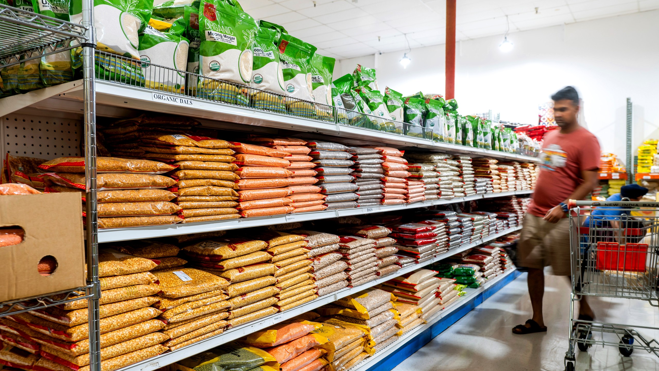 A customer shops a grain isle at New India Bazar, where most merchandise is imported from India and Canada, on Wednesday, Aug. 6, 2025, in Fremont, Calif. (AP Photo/Noah Berger)