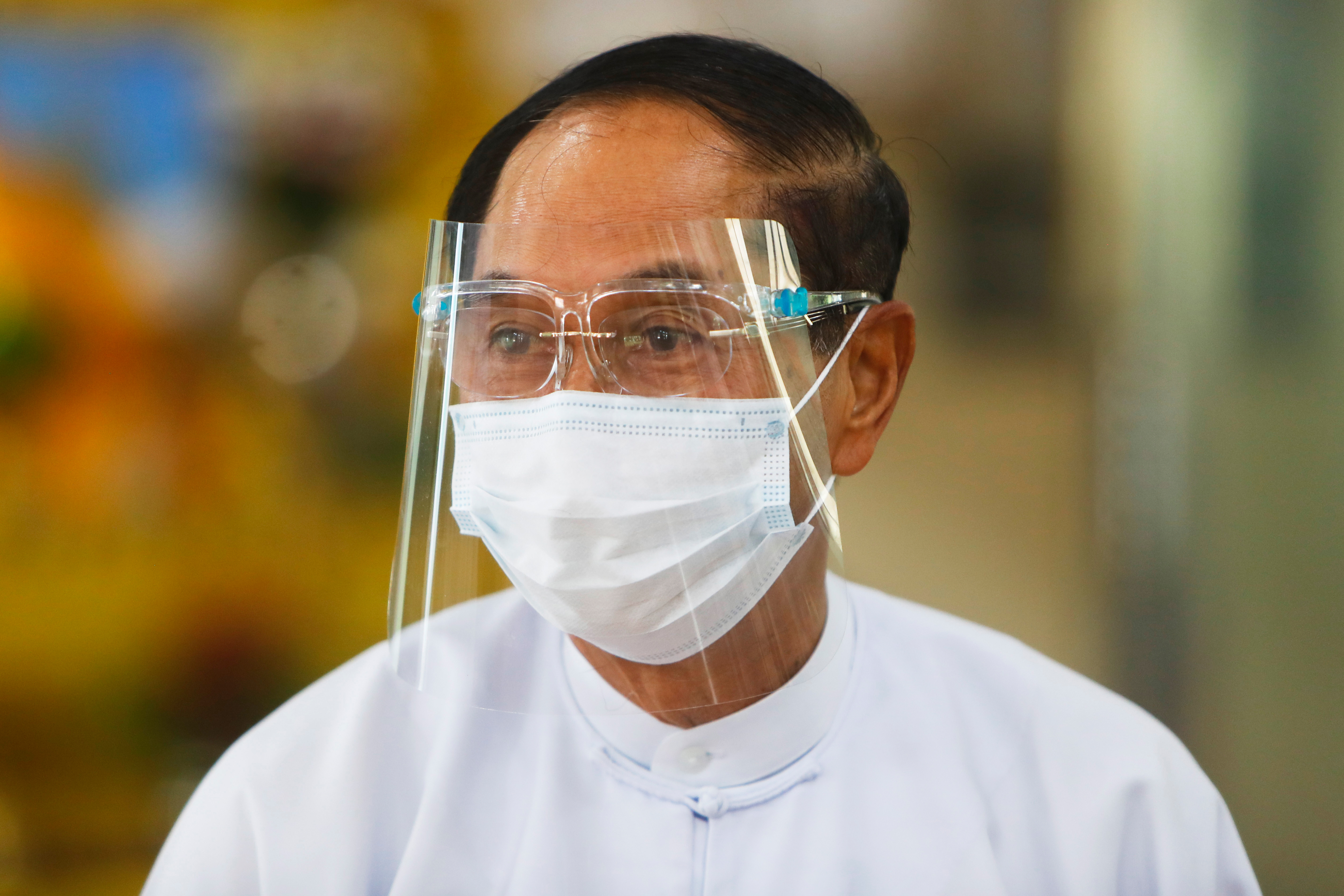 FILE - Myanmar Vice President Myint Swe leaves after he makes an early voting for the upcoming Nov. 8 general election at a polling station Oct. 30, 2020, in Naypyitaw, Myanmar. (AP Photo/Aung Shine Oo, File)