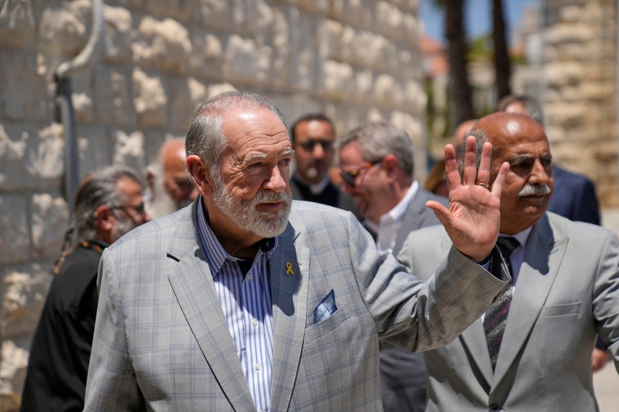 FILE - U.S. Ambassador to Israel Mike Huckabee waves upon his arrival in the West Bank town of Taybeh, east of Ramallah Saturday, July 19, 2025. (AP Photo/Nasser Nasser, File)
