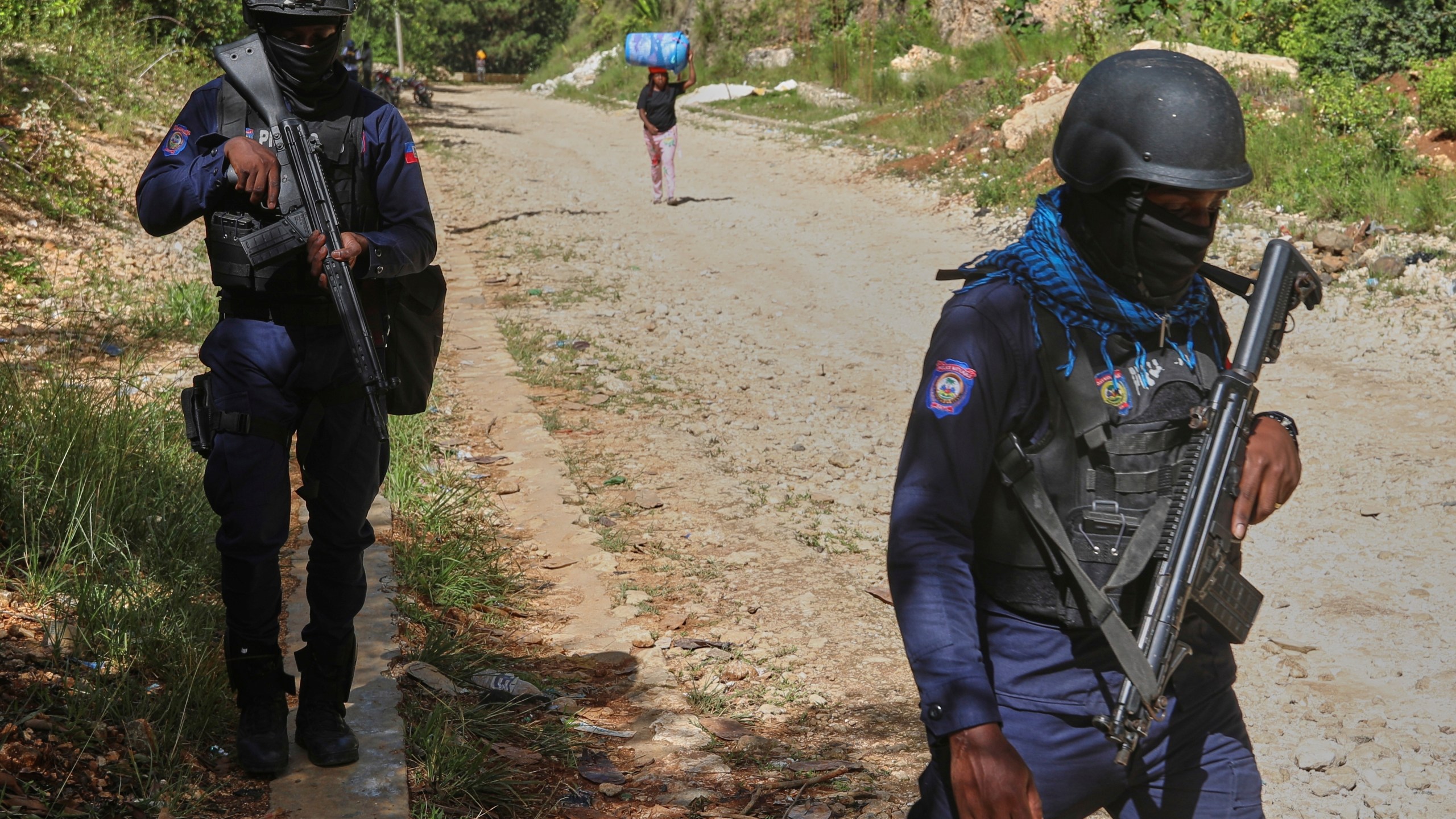 Police officers patrol the area near the Saint-Helene orphanage in the Kenscoff neighborhood of Port-au-Prince, Haiti, Monday, Aug. 4, 2025. (AP Photo/Odelyn Joseph)