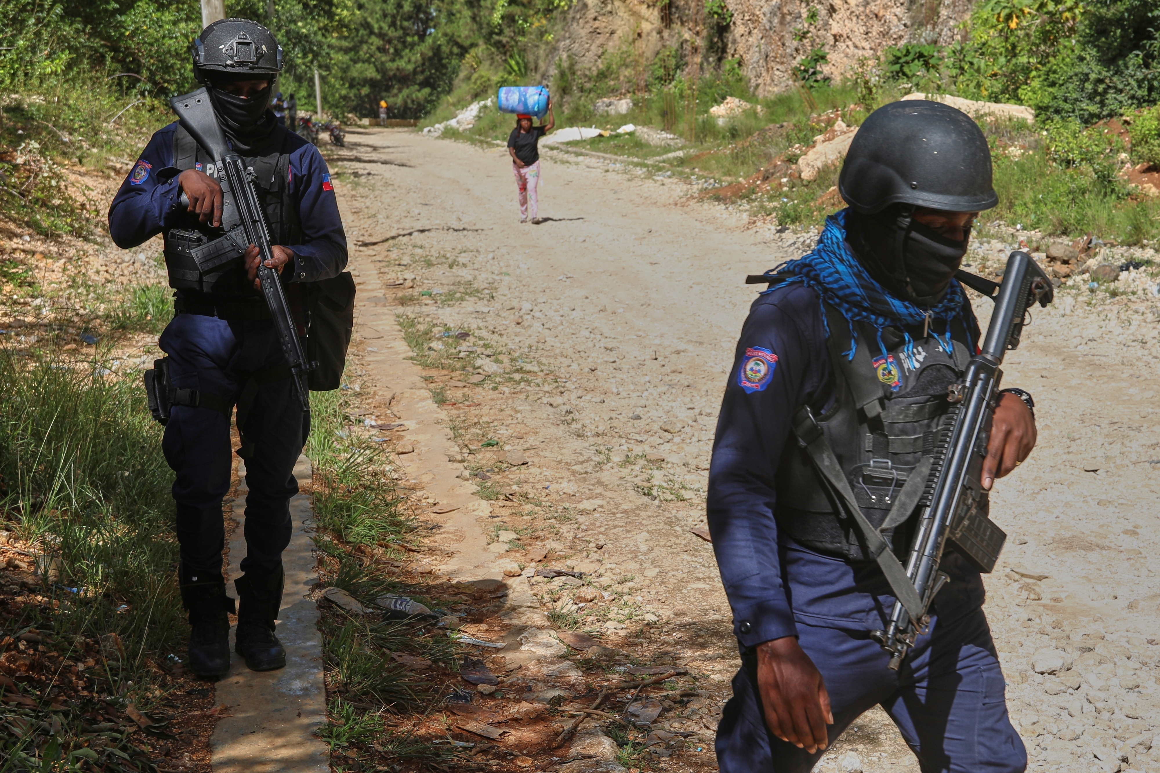 Police officers patrol the area near the Saint-Helene orphanage in the Kenscoff neighborhood of Port-au-Prince, Haiti, Monday, Aug. 4, 2025. (AP Photo/Odelyn Joseph)