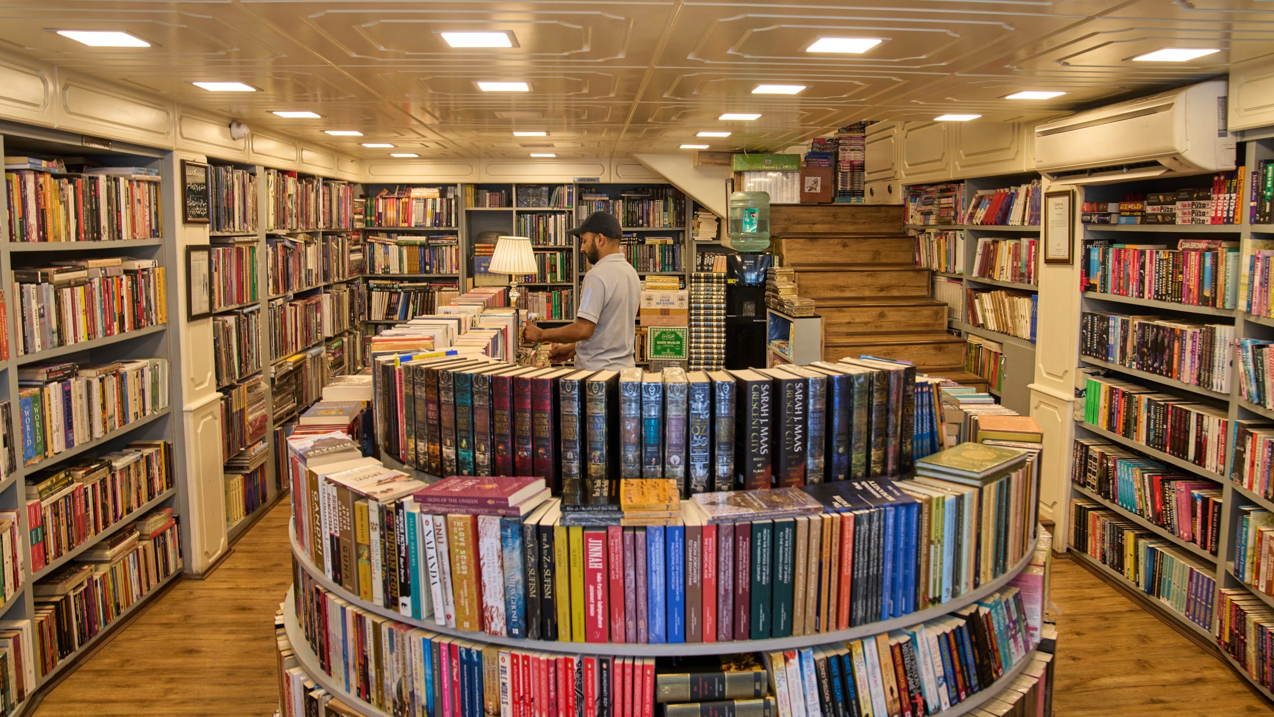 A Kashmiri man arranges books in a bookstore in Srinagar, Indian controlled Kashmir, Thursday, Aug. 7, 2025. (AP Photo/ Dar Yasin )