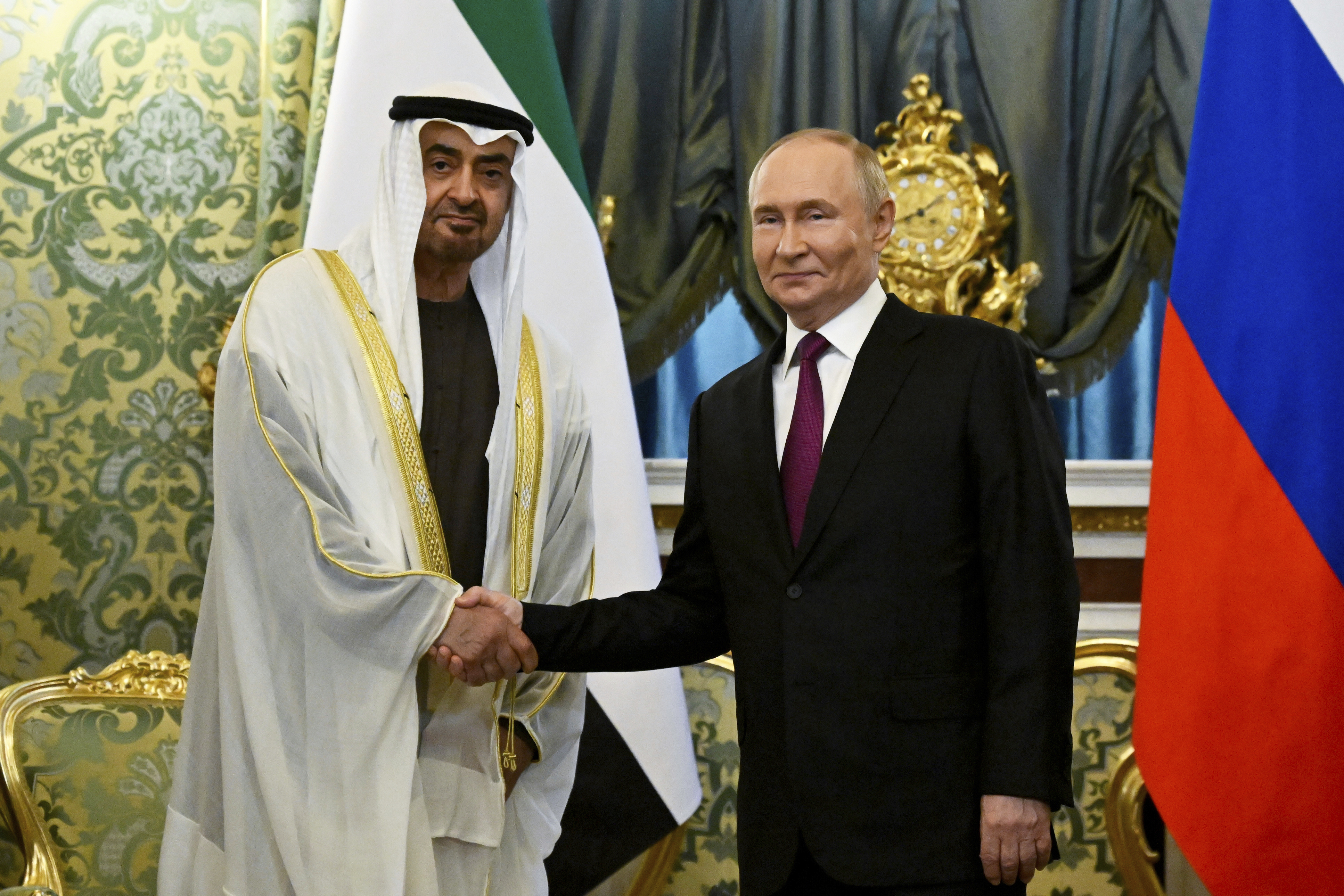 Russian President Vladimir Putin, right, and United Arab Emirates President Sheikh Mohammed bin Zayed Al Nahyan shake hands during their meeting at the Grand Kremlin Palace in Moscow, Russia, Thursday, Aug. 7, 2025. (Alexander Nemenov/Pool Photo via AP)