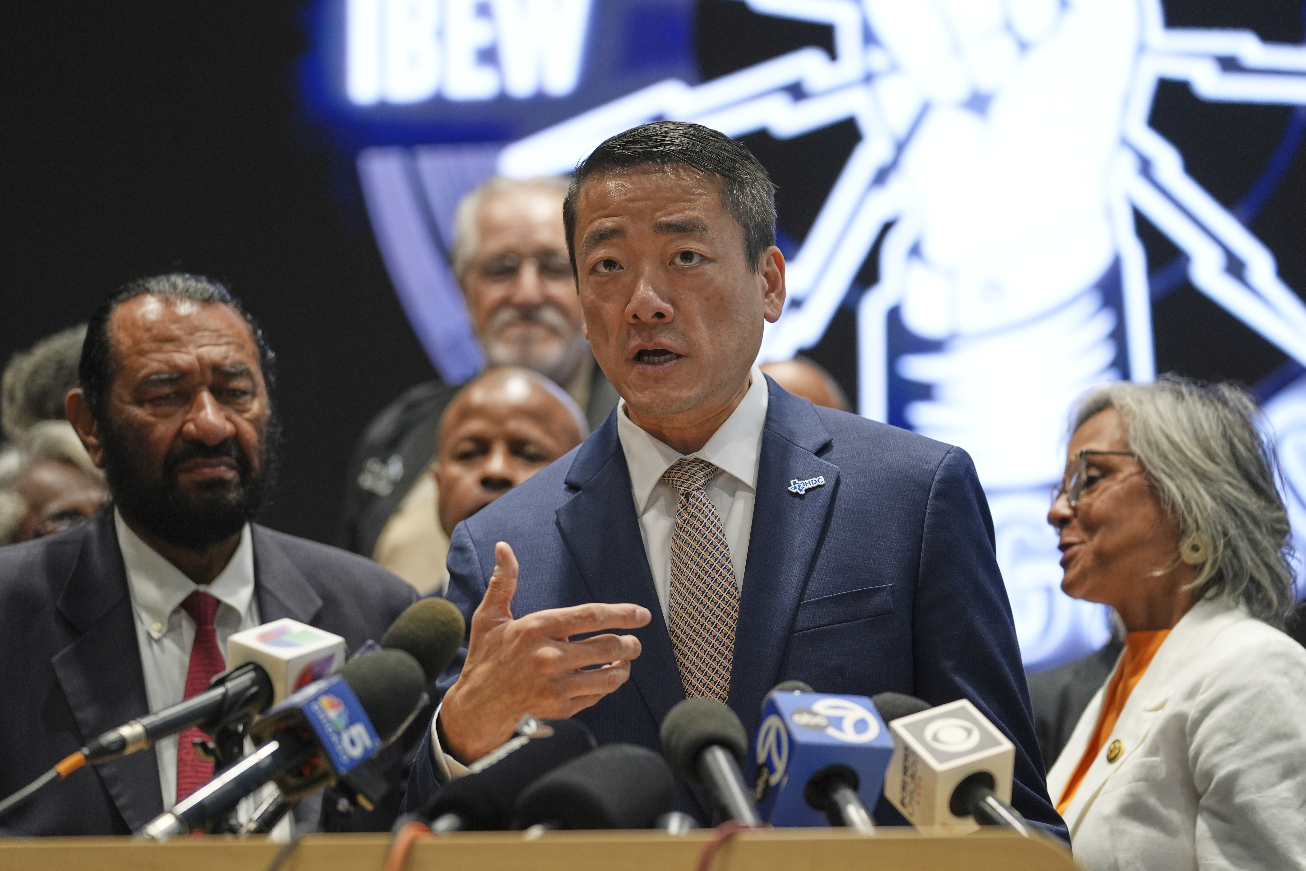 Democratic Texas Rep. Gene Wu, center, surrounded by other Texas House Democrats and Democratic members of Congress, speaks during a press conference at the Democratic Party in Warrenville, Ill., Monday, Aug. 4, 2025. (AP Photo/Nam Y. Huh)
