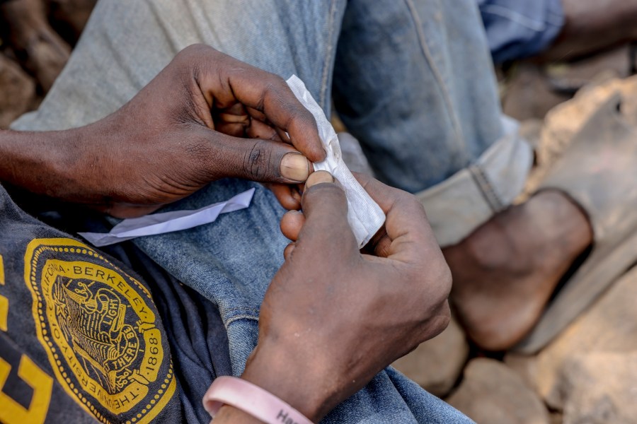 FILE - A boy rolls kush at the Baghdad Den in Freetown, Sierra Leone, March 11, 2025. (AP Photo/Caitlin Kelly, File)