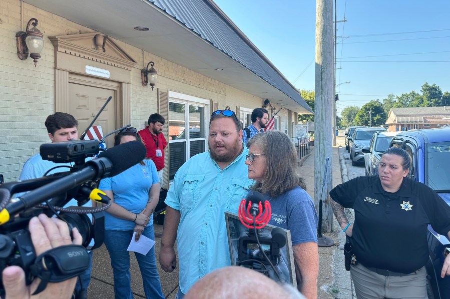 The parents of James M. Wilson, Matthew Wilson, left, and Kim Hamil, speak with reporters after a court hearing for a man charged with killing four people, Thursday, Aug. 7, 2025, in Tiptonville, Tenn. (AP Photo/Adrian Sainz)