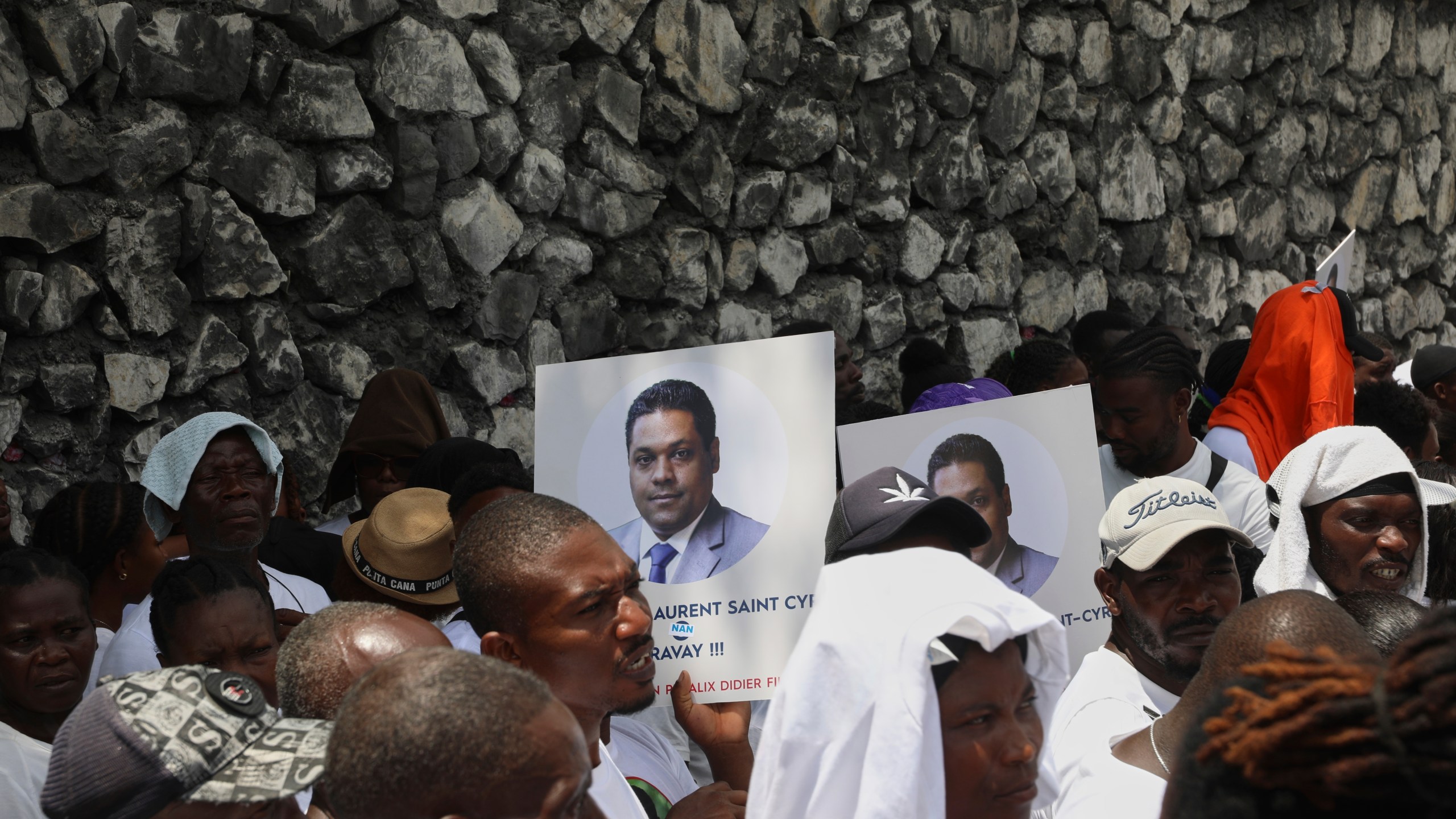 Supporters celebrate the installation of Laurent Saint-Cyr, who replaces Fritz Alphonse Jean, in the rotating presidency of the transitional presidential council in Port-au-Prince, Haiti, Thursday, Aug. 7, 2025. (AP Photo/Odelyn Joseph)